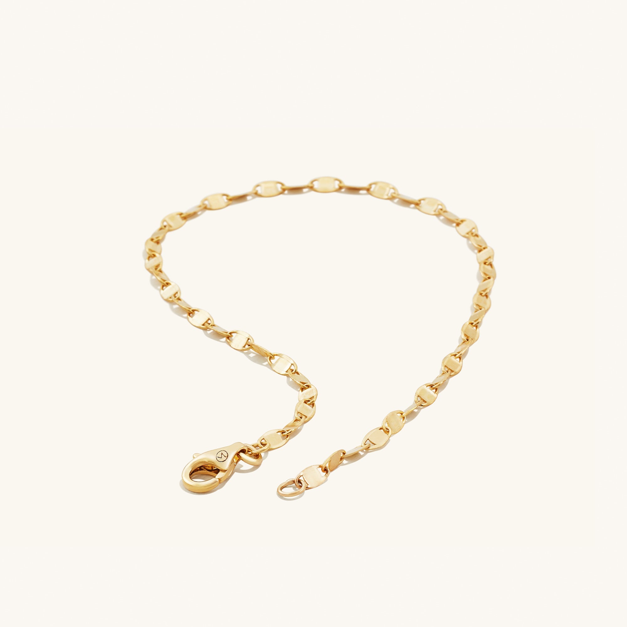 Anchor Chain Anklet: A handcrafted 14k solid gold chain with interconnected links and a clasp, resembling a ship's anchor chain.