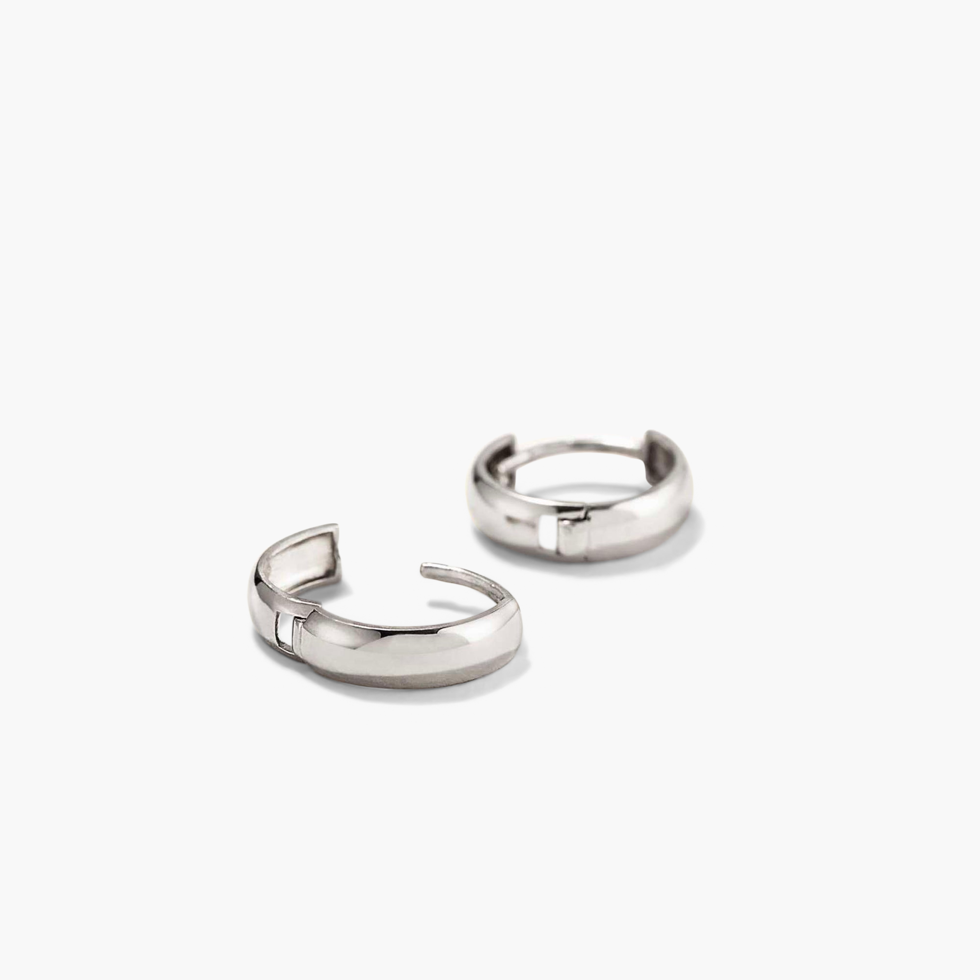 Bold Huggie Hoops: a pair of silver hoop earrings, known for their outfit-elevating and mood-boosting qualities, prominently featured in the image.
