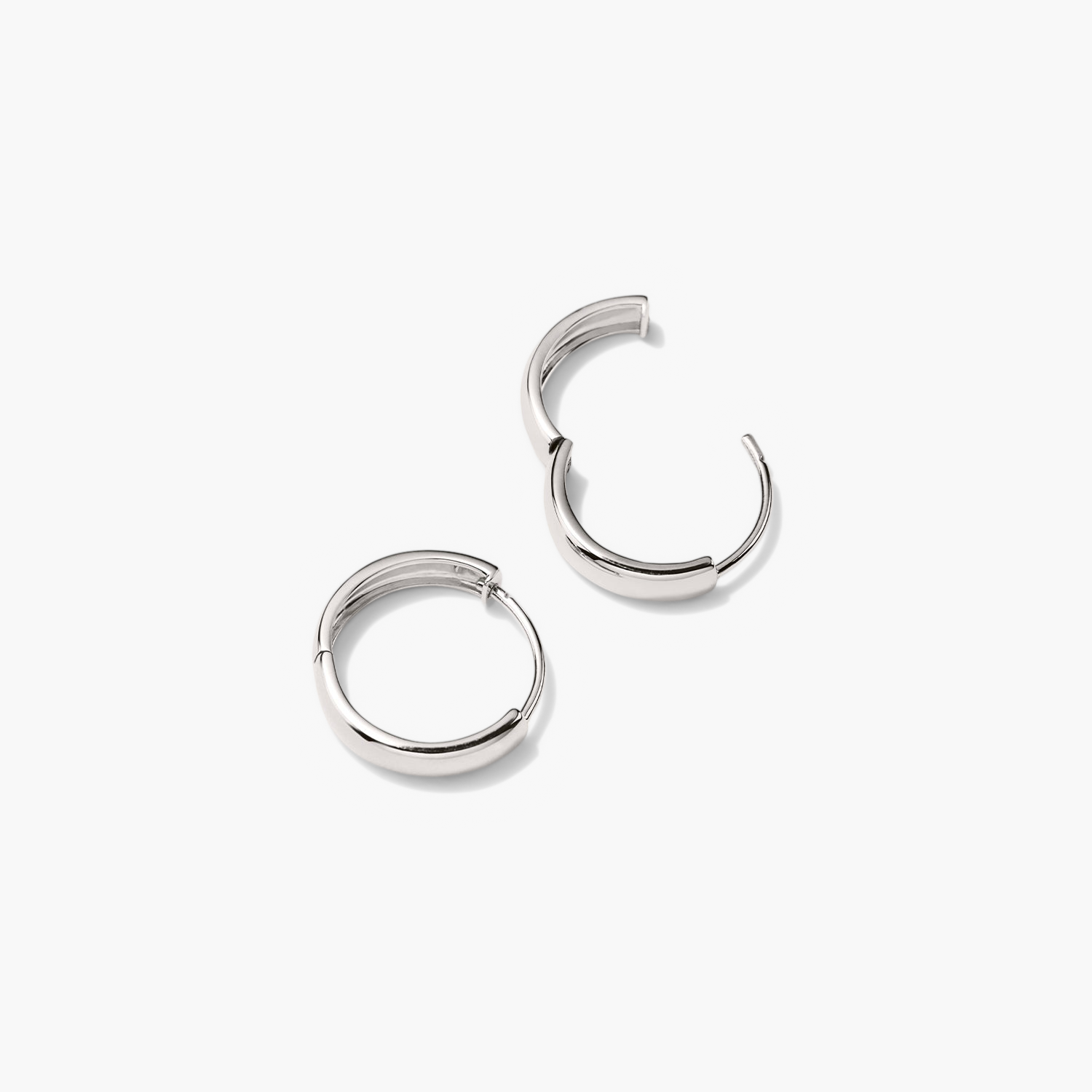 Bold Small Hoops: A pair of silver hoop earrings, fashion accessories that elevate any outfit with their elegant design and timeless appeal.