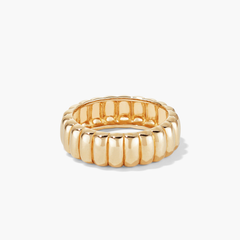 Gold ring with a curved design, named Charlotte Ring. Inspired by French desserts, it adds elegance to any fashion accessory collection.