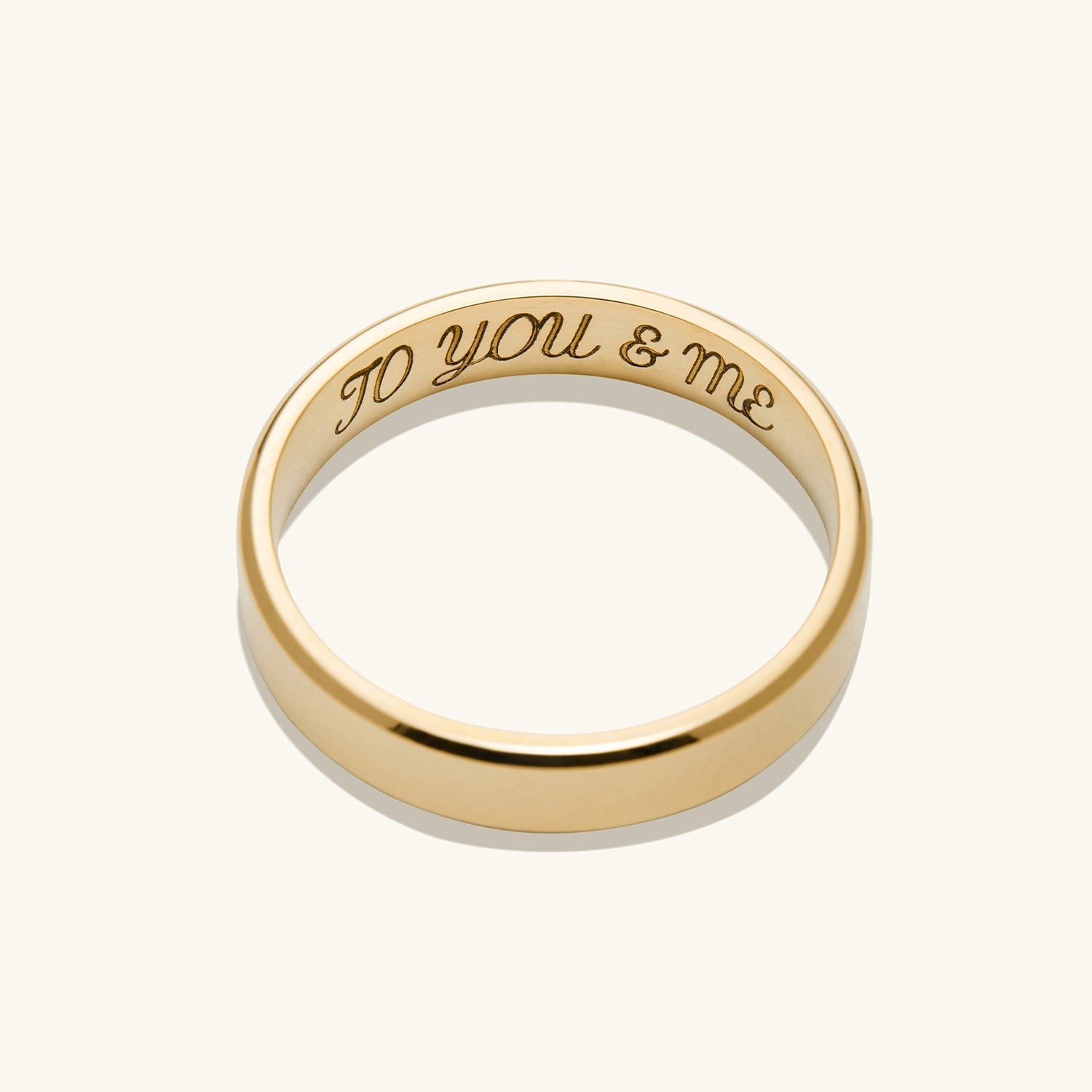 Gold ring with engraved text, titled 4mm Smooth Band, lightweight and durable, perfect for marking significant life milestones.
