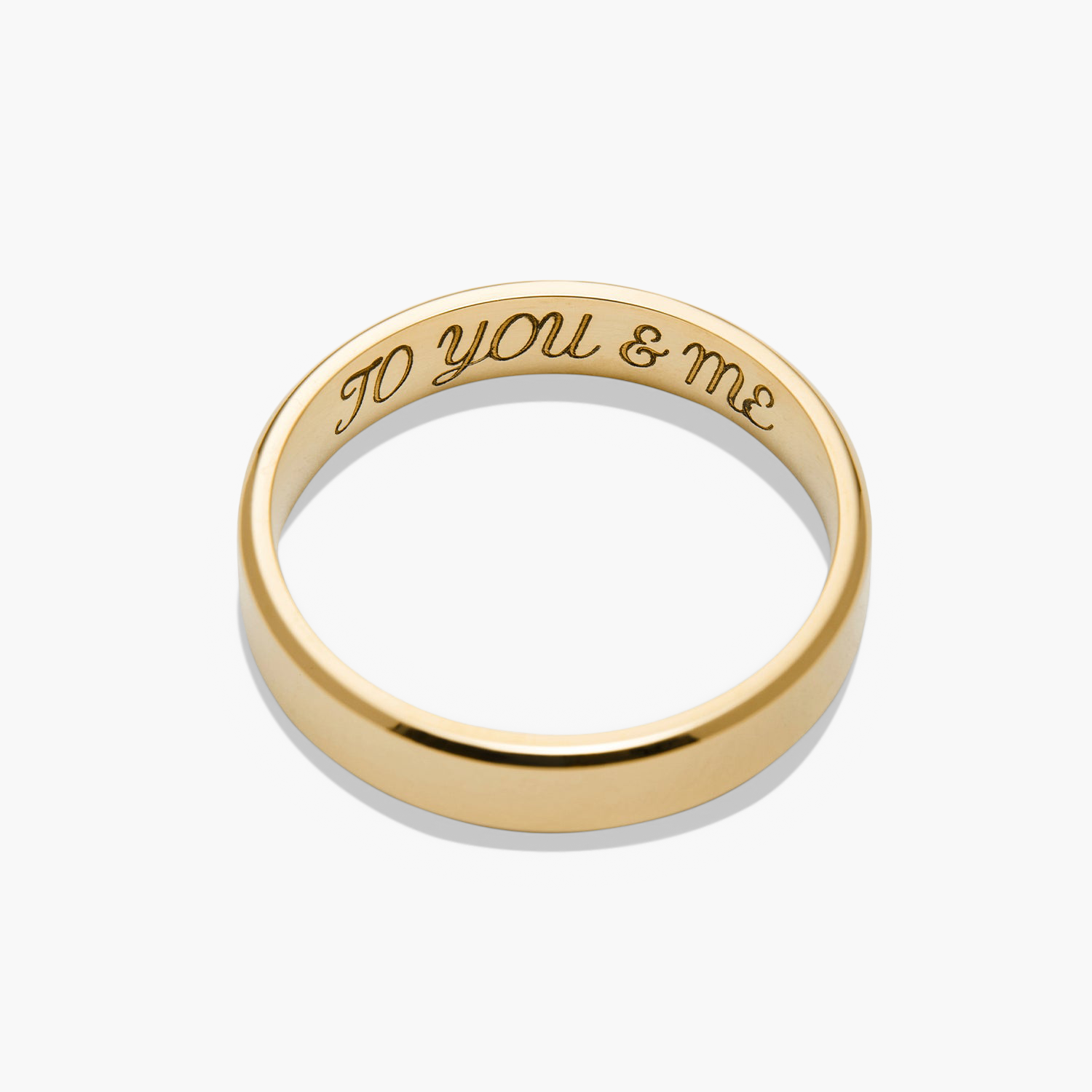 Gold ring with engraved text, titled 4mm Smooth Band, lightweight and durable, perfect for marking significant life milestones.