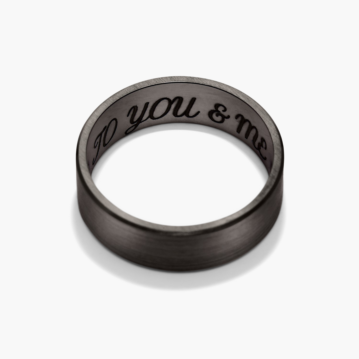 6mm Smooth Band engraved with text, showcasing a close-up of the ring's detailed etching, highlighting its lightweight and lasting design for your next chapter.