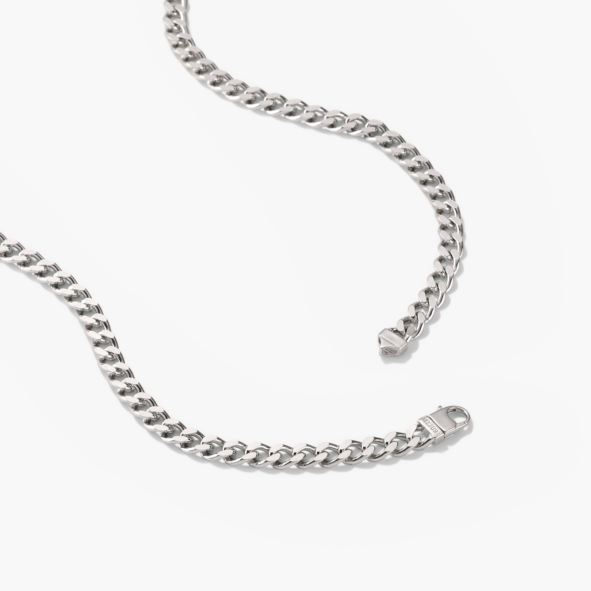 5mm Curb Chain Necklace: A silver chain with a close-up of its metal clasp, designed for versatile everyday wear and statement style.