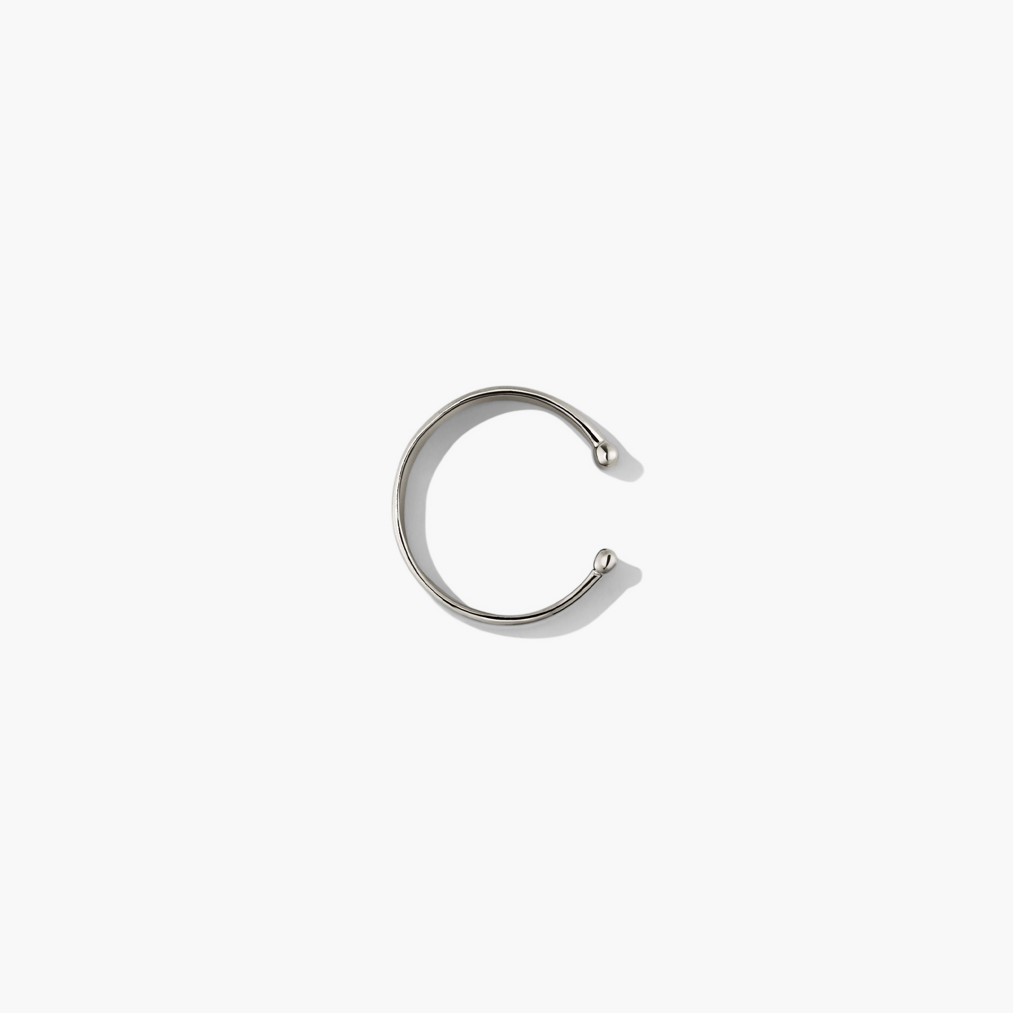 Daily Ear Cuff: A polished silver cuff, handcrafted with a thick 18k gold layer on sterling silver, offering high-impact shine and timeless elegance.