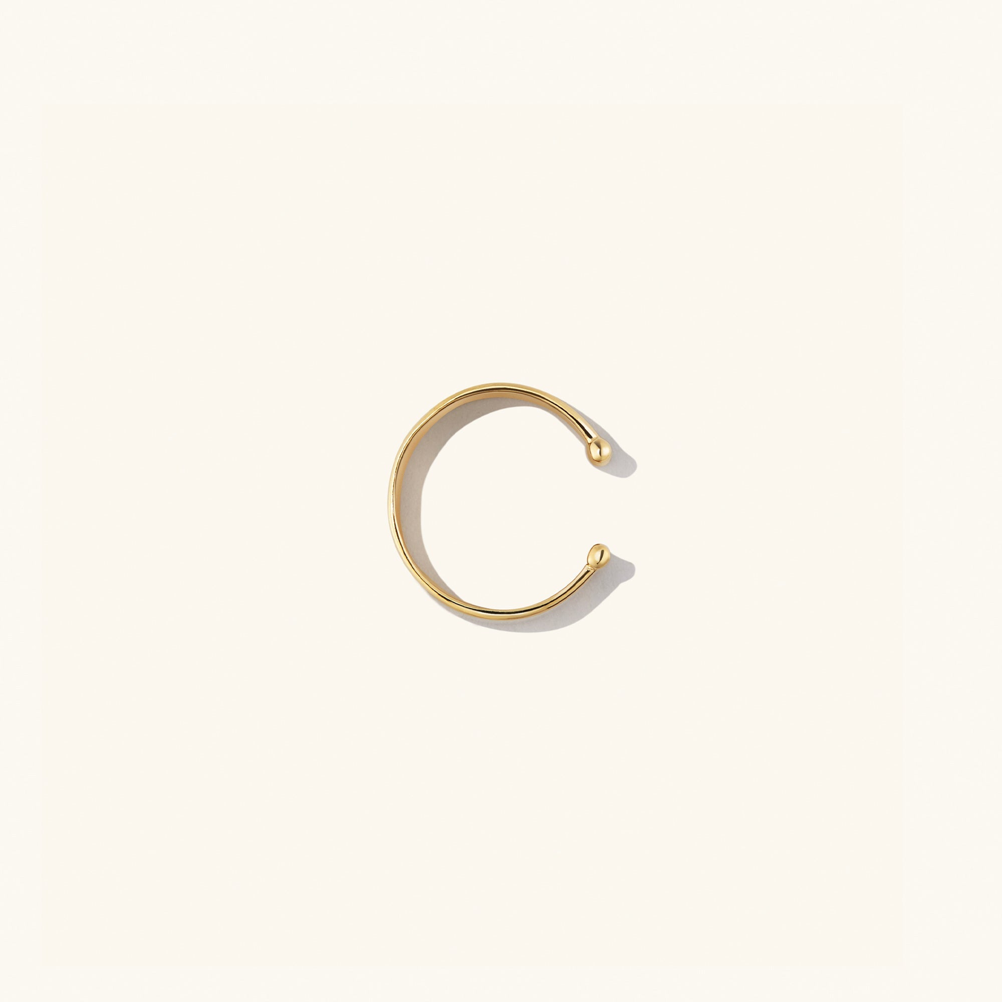 Daily Ear Cuff in vermeil, showcasing a sleek, polished design, perfect as an essential accessory with high-impact shine for versatile styling.