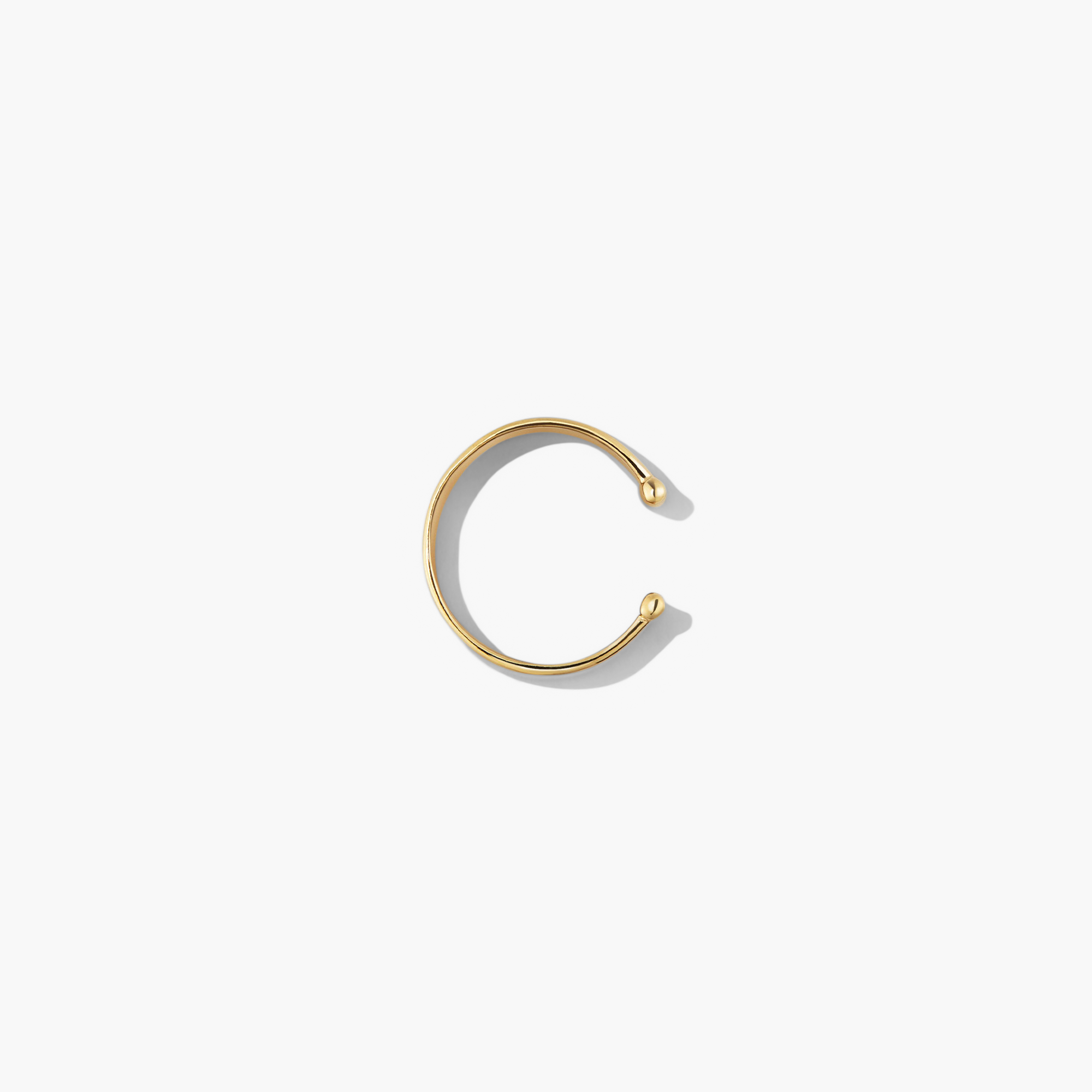 Daily Ear Cuff in vermeil, showcasing a sleek, polished design, perfect as an essential accessory with high-impact shine for versatile styling.