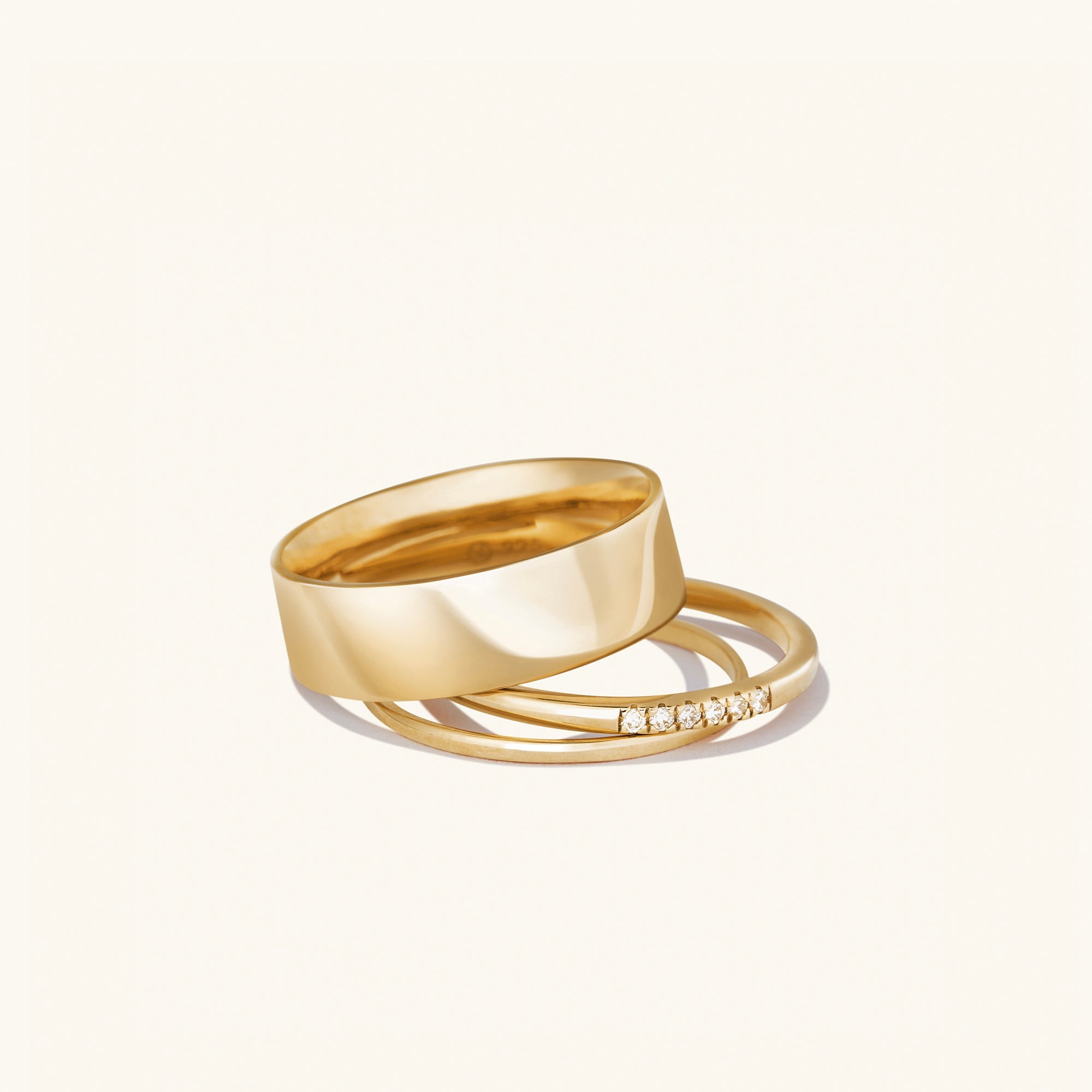 Daily Stacker Ring: A stack of elegant gold rings, showcasing their sleek design, perfect for layering as a stylish fashion accessory.