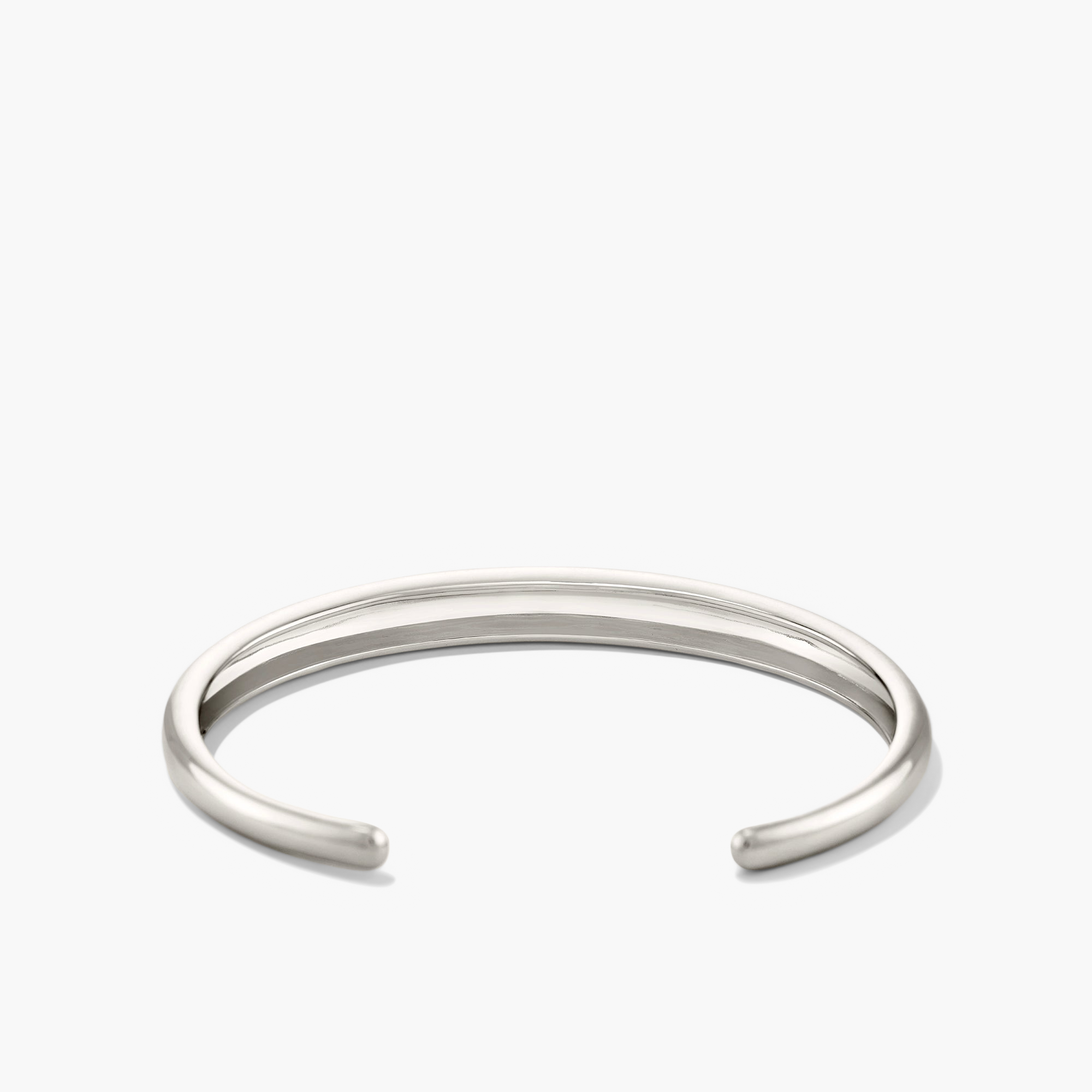 Silver DÃ´me Cuff Bracelet on white background, showcasing intricate design inspired by a ray of sunshine.