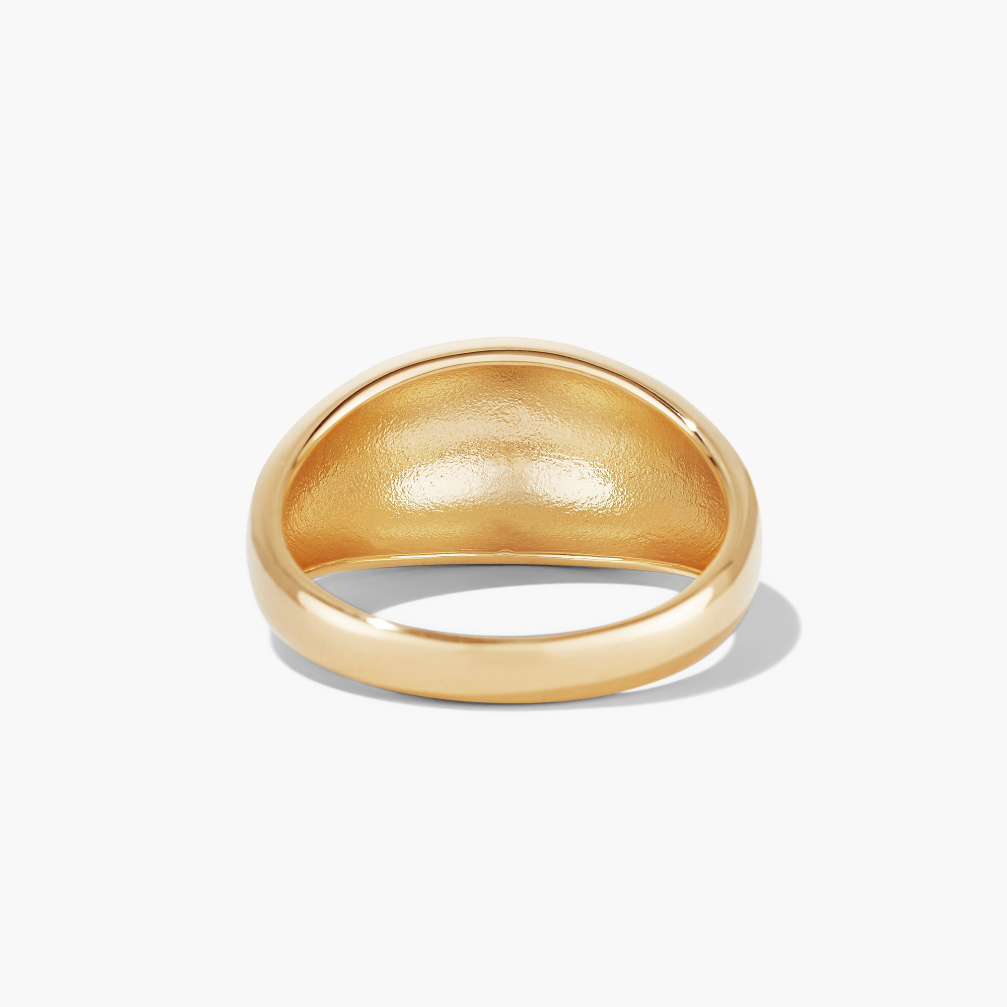 DÃ´me Ring: A sleek gold ring with a bold design, perfect for stacking with daintier rings.