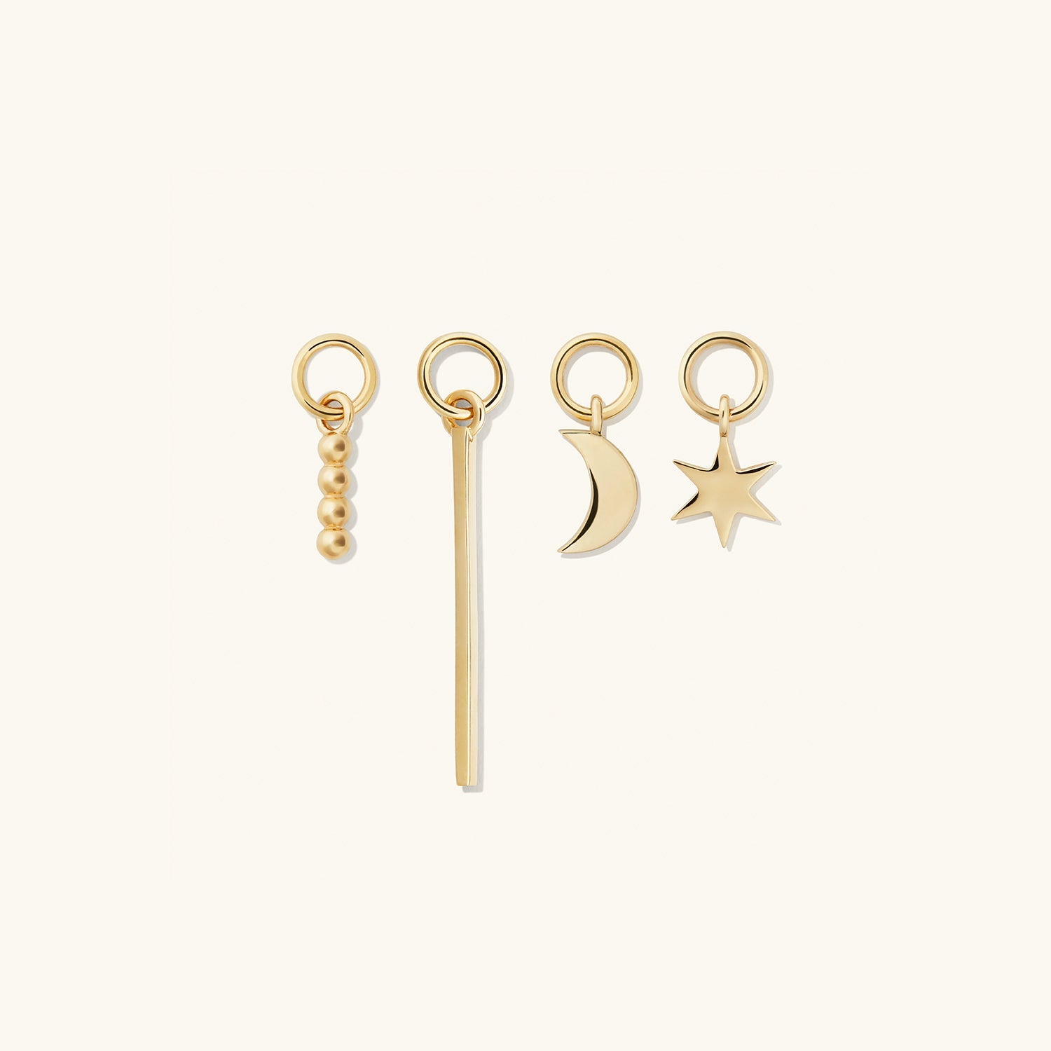 Single Bar Hoop Charm displayed among other gold charms, including rings and a star keychain. Enhance your hoops with this versatile, elegant addition.