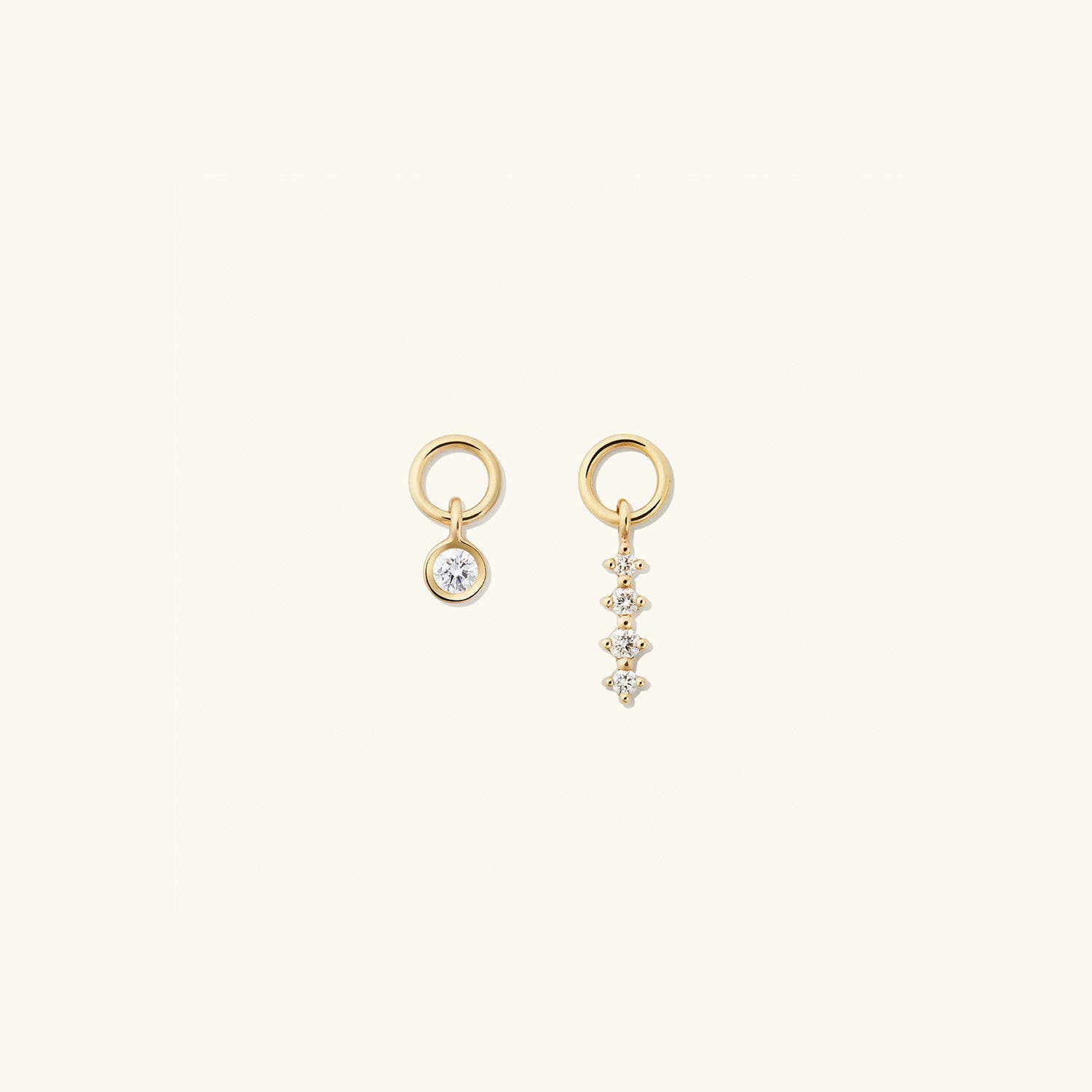 Single Diamond Icicle Hoop Charm: A pair of gold earrings with a diamond accent, ideal for customizing and enhancing everyday hoops with a high-impact look.