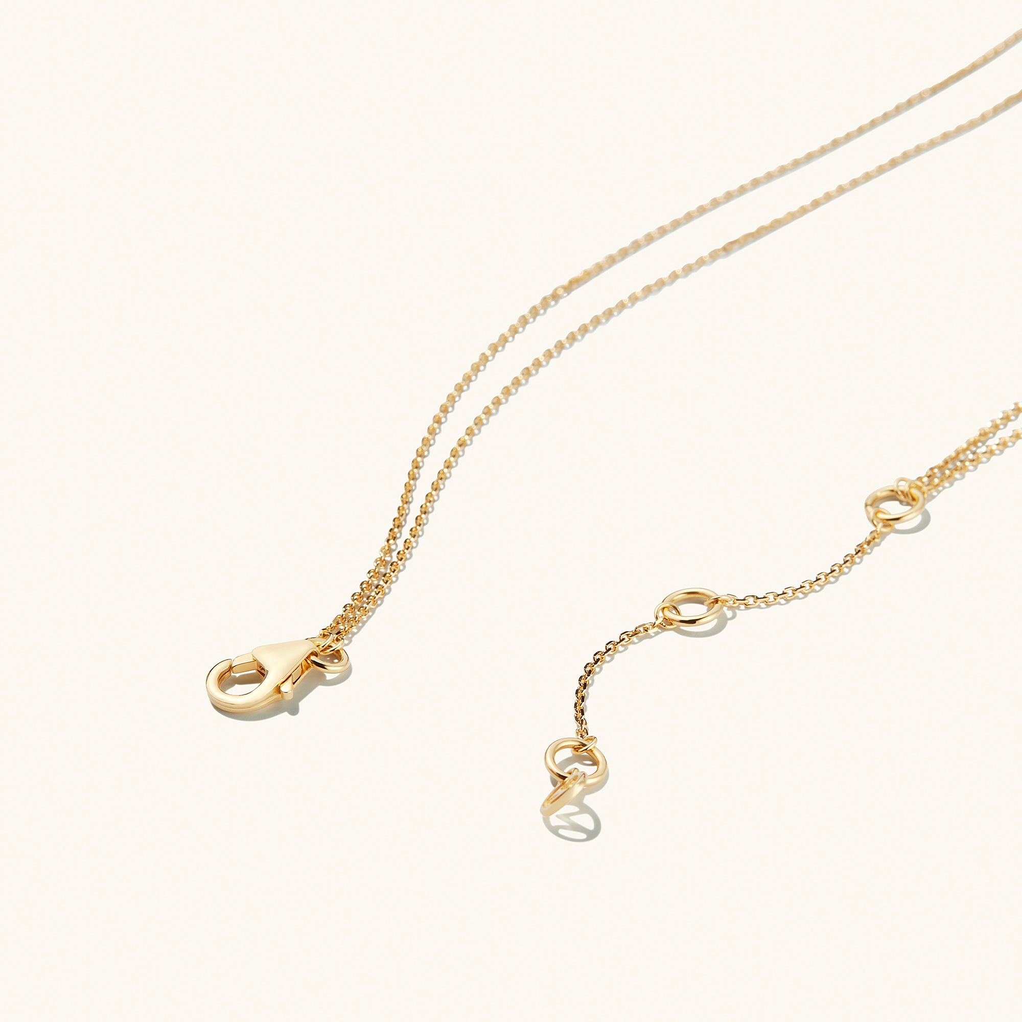 Layered Opal Necklace featuring two gold chains seamlessly bound with a natural opal pendant, showcasing intricate links and a polished finish.