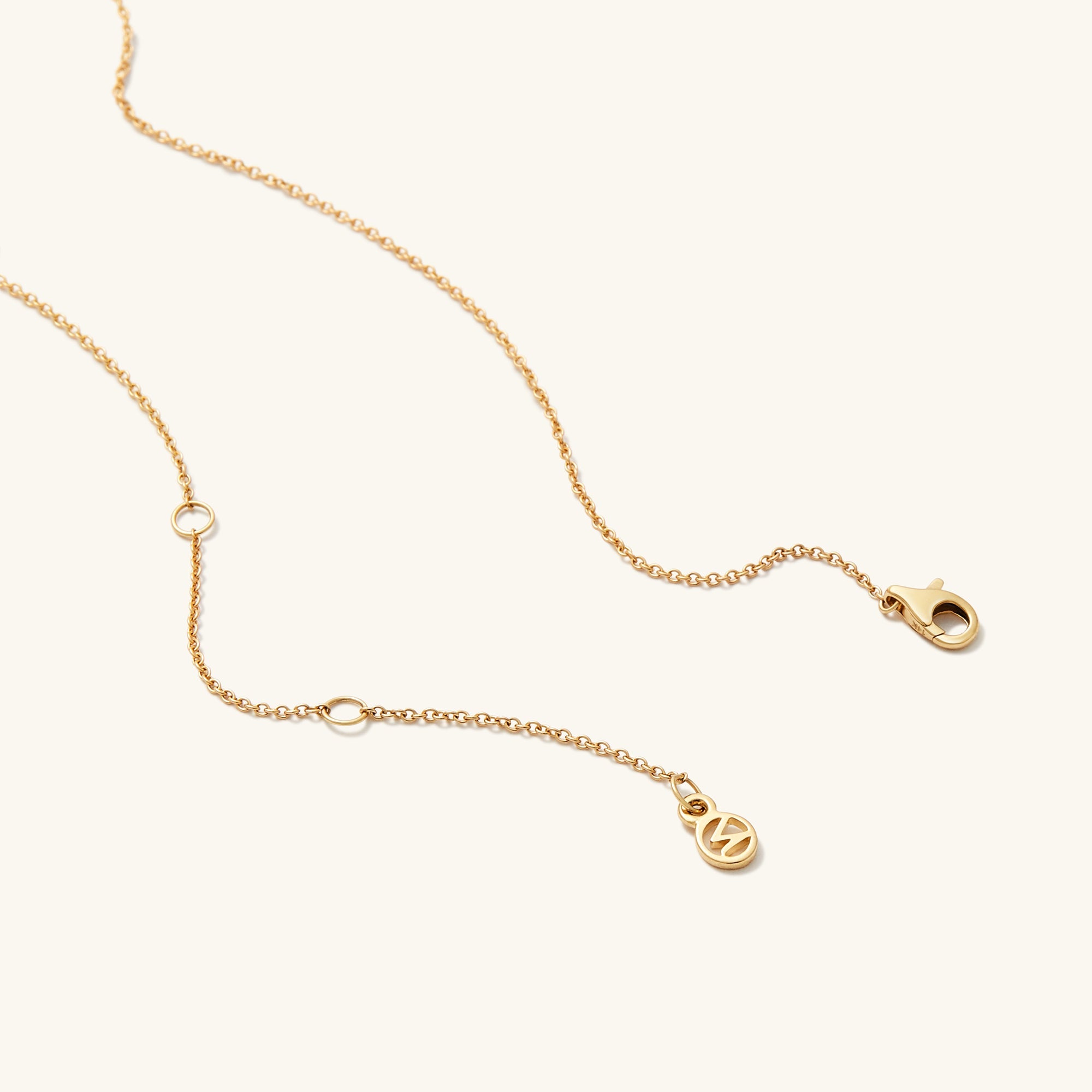 PavÃ© Diamond Linked Necklace showcasing two interlinked rings on a gold chain, symbolizing personal bonds, with diamonds compliant with the Kimberley Process.
