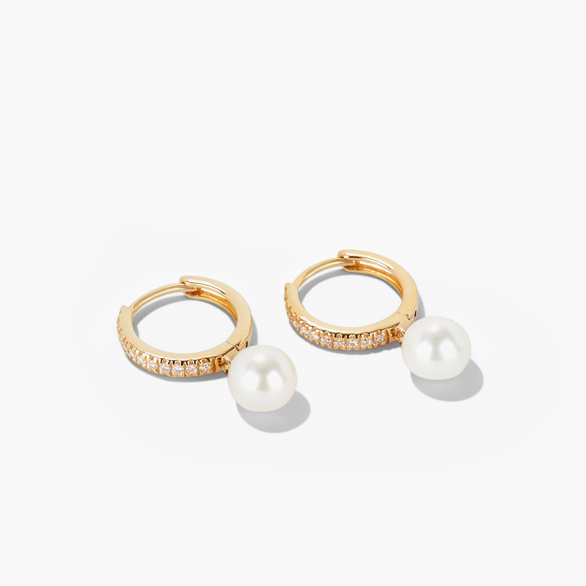 PavÃ© Diamond Pearl Huggies: A pair of 14k gold hoop earrings featuring 22 pavÃ©-set diamonds and a round freshwater pearl.