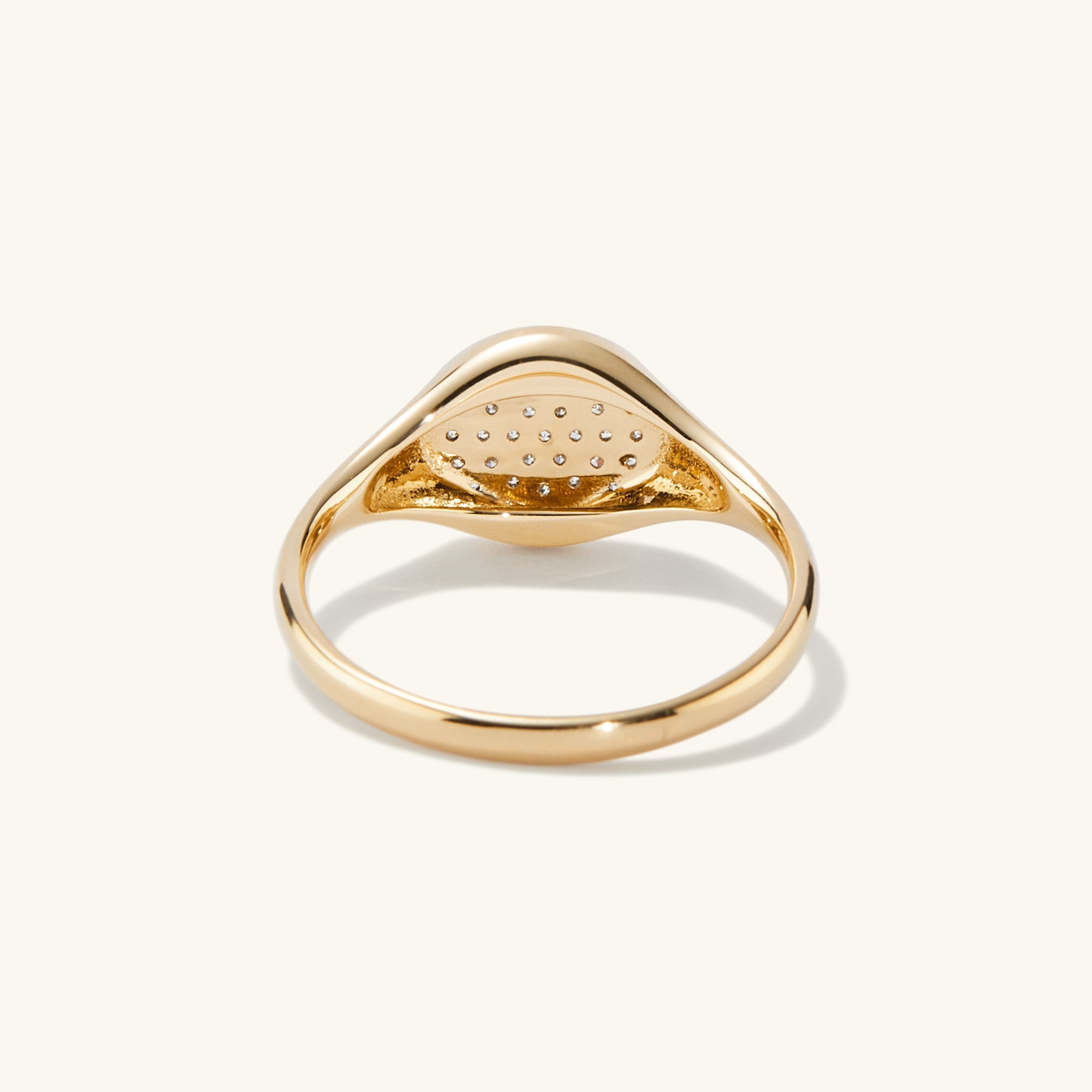 PavÃ© Diamond Signet Pinky Ring featuring a central diamond surrounded by pavÃ©-set diamonds, showcasing a refined and elegant fashion accessory.