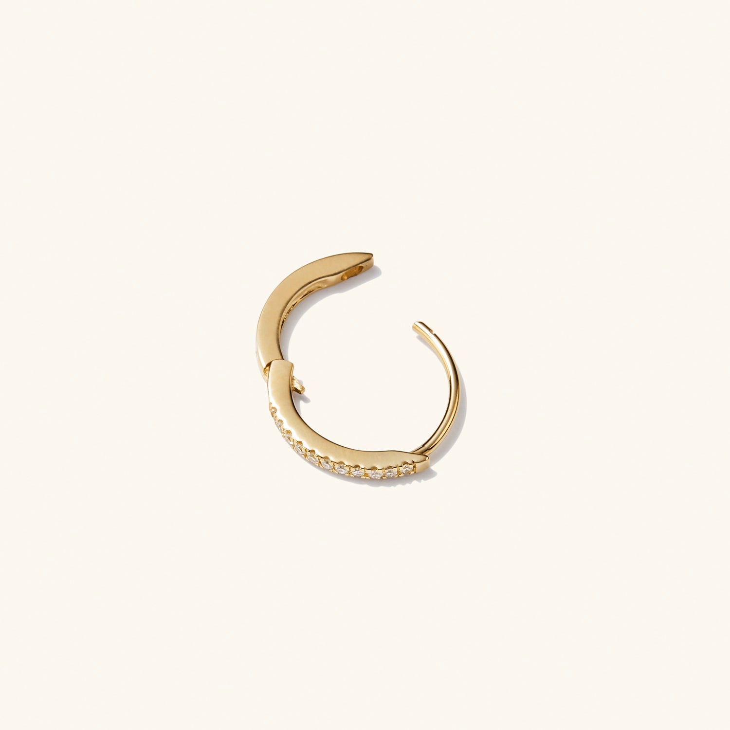 Single PavÃ© Diamond Huggie Hoop in recycled 14k solid gold, featuring diamonds for a versatile, stackable earring designed to elevate any outfit.