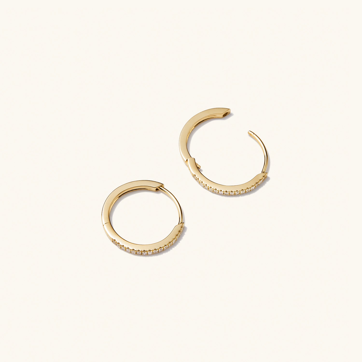 PavÃ© Diamond Small Hoops: A pair of handcrafted 14k solid gold hoop earrings, featuring pavÃ© diamonds, designed for versatile wear.