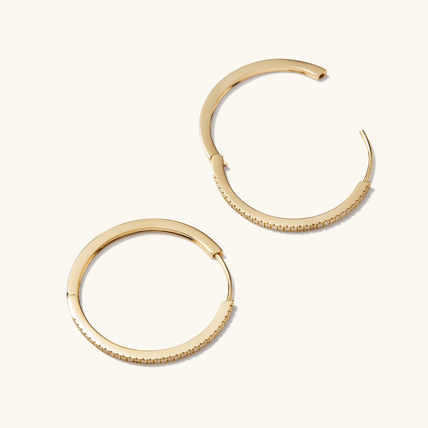 PavÃ© Diamond Large Hoops: A pair of gold hoop earrings with pavÃ© diamonds, handcrafted in recycled 14k solid gold, designed for versatile wear.