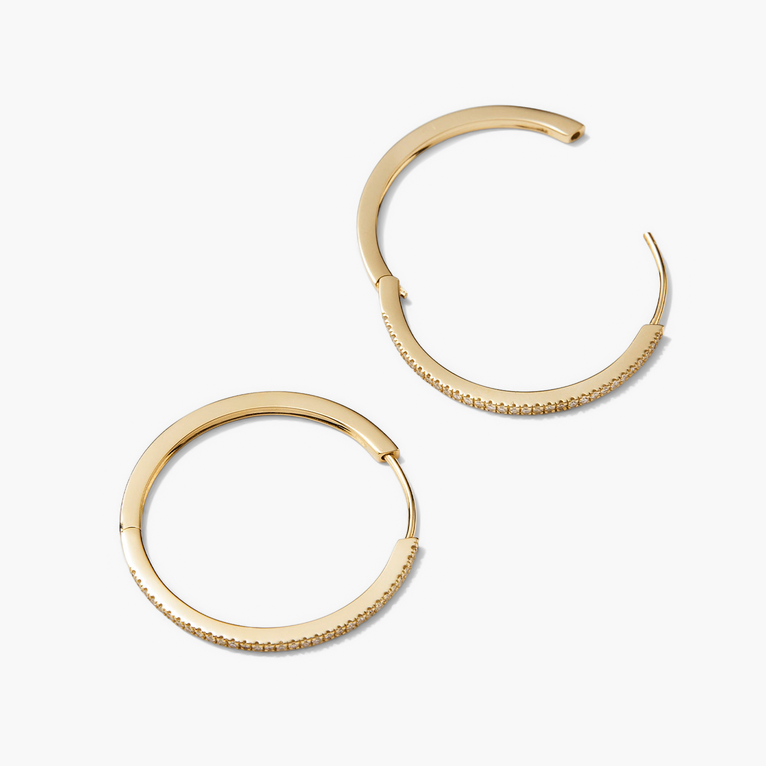 PavÃ© Diamond Large Hoops: A pair of gold hoop earrings with pavÃ© diamonds, handcrafted in recycled 14k solid gold, designed for versatile wear.
