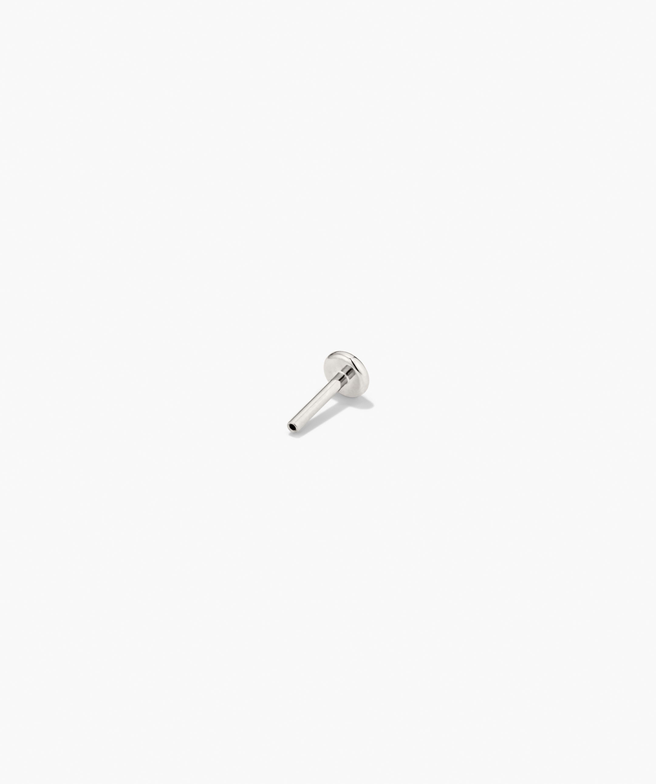 Polished metal pin resembling a labret stud, part of Piercing Studio's Lab Grown Diamond Drop Studs, offering a subtle, sculptural earring design.
