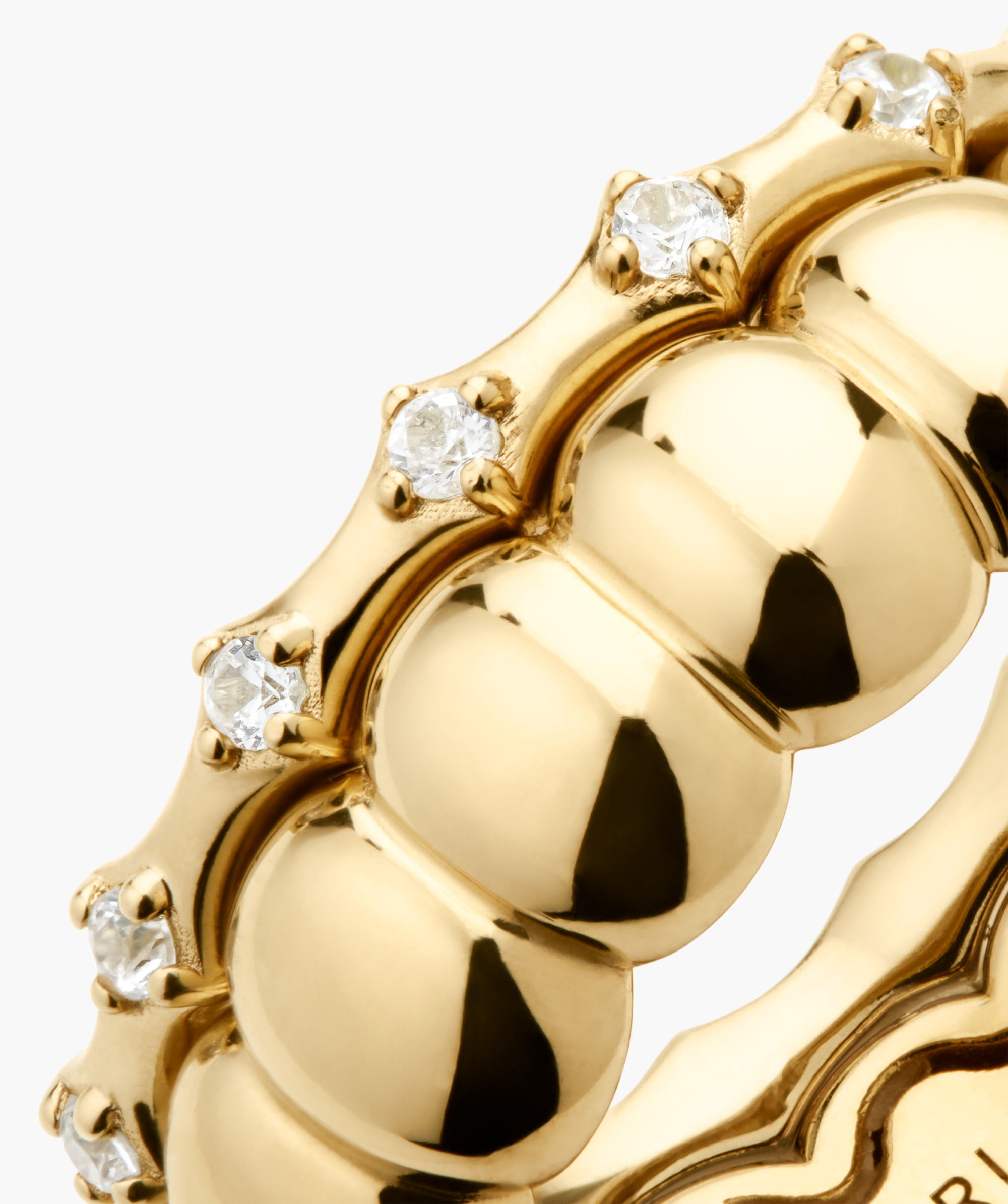 Classic Charlotte Stacker Bundle: Close-up of polished yellow-gold bands with domed beads and round diamonds in four-prong settings, showcasing fine-jewelry craftsmanship.