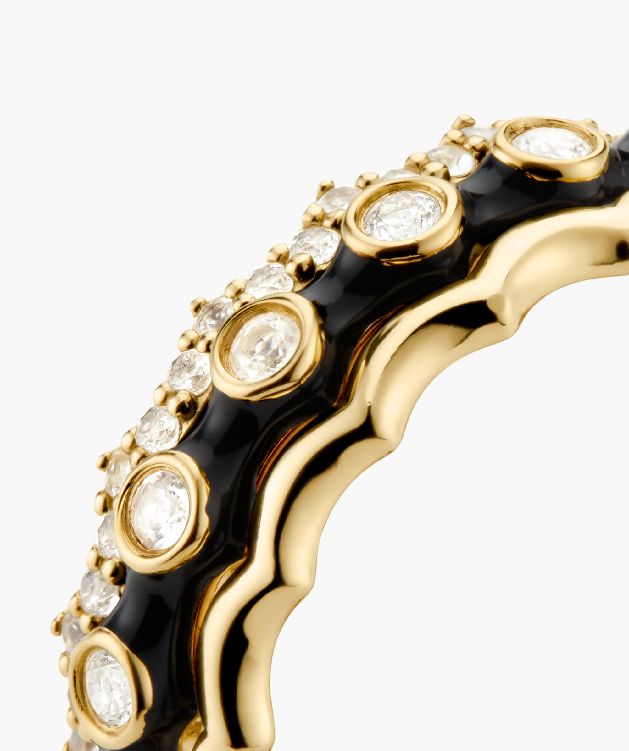 Gemstone Charlotte Stacker Bundle featuring a sculptural gold band with glossy black enamel, adorned with white gemstones, showcasing contrast in color and design.