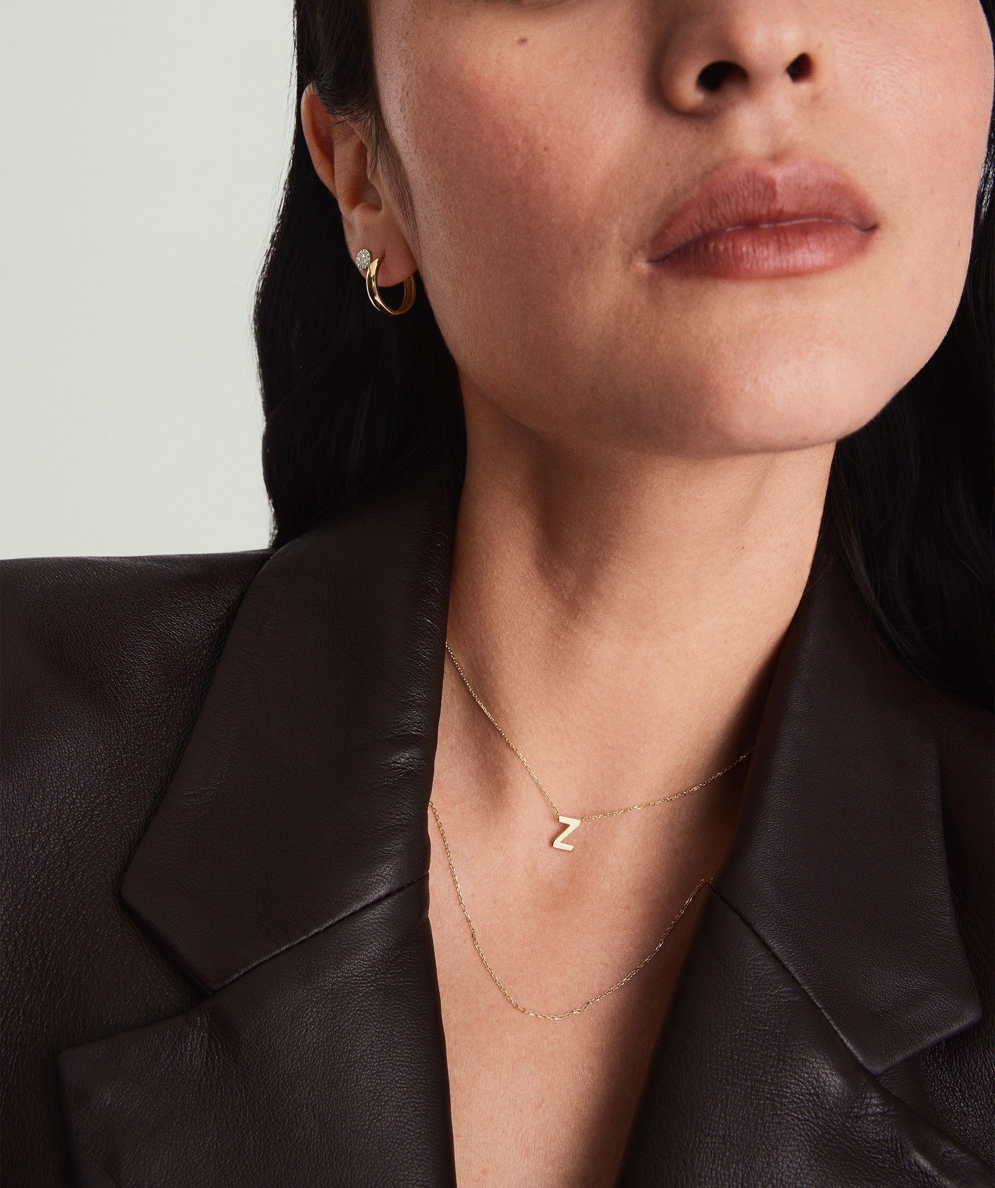 Close-up of a woman wearing a chain necklace, ideal for adding charms or layering with other necklaces and chokers.