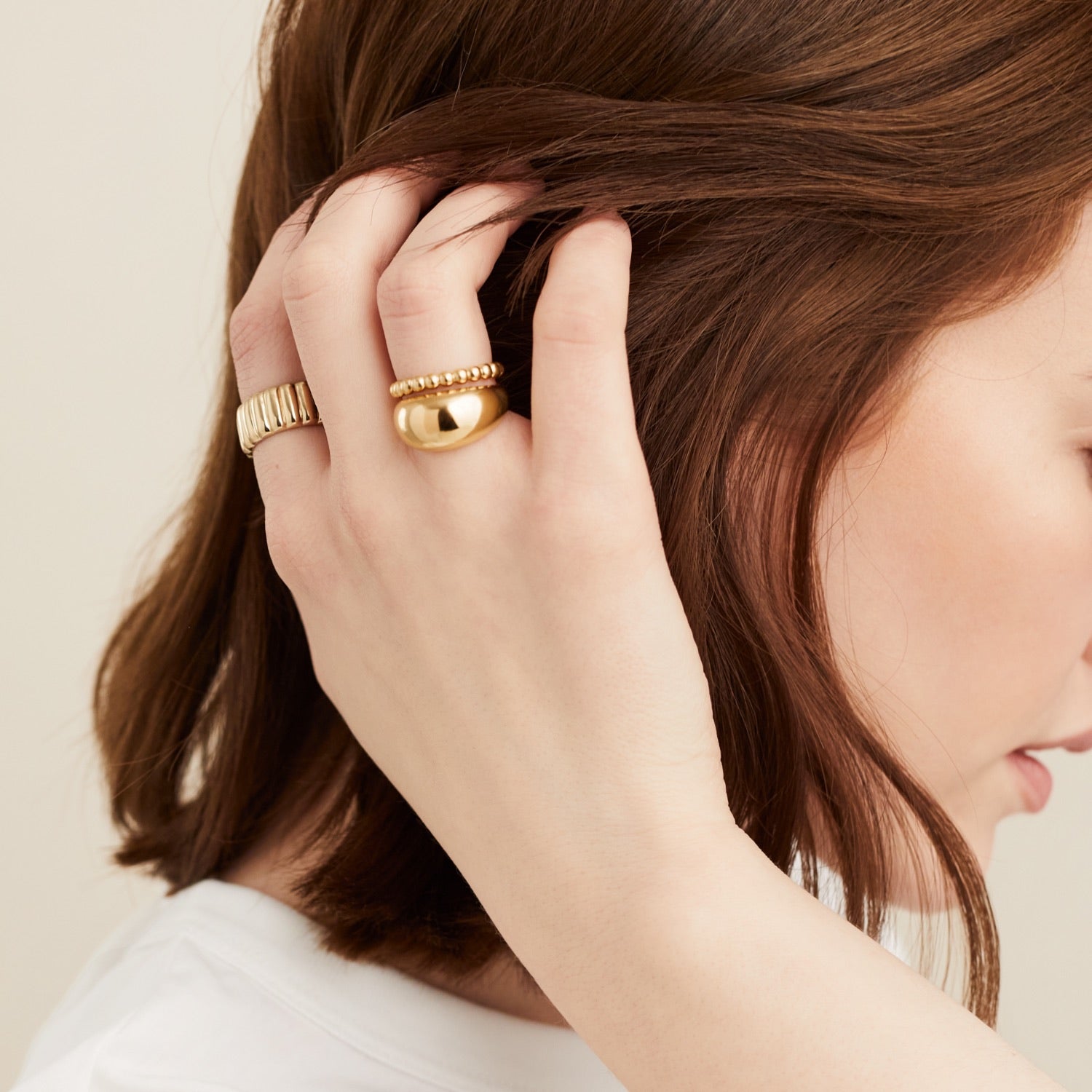 Close-up of a woman's hand adorned with the Metallic Sphere Ring, handcrafted in 18k gold vermeil, highlighting its bold and timeless design.