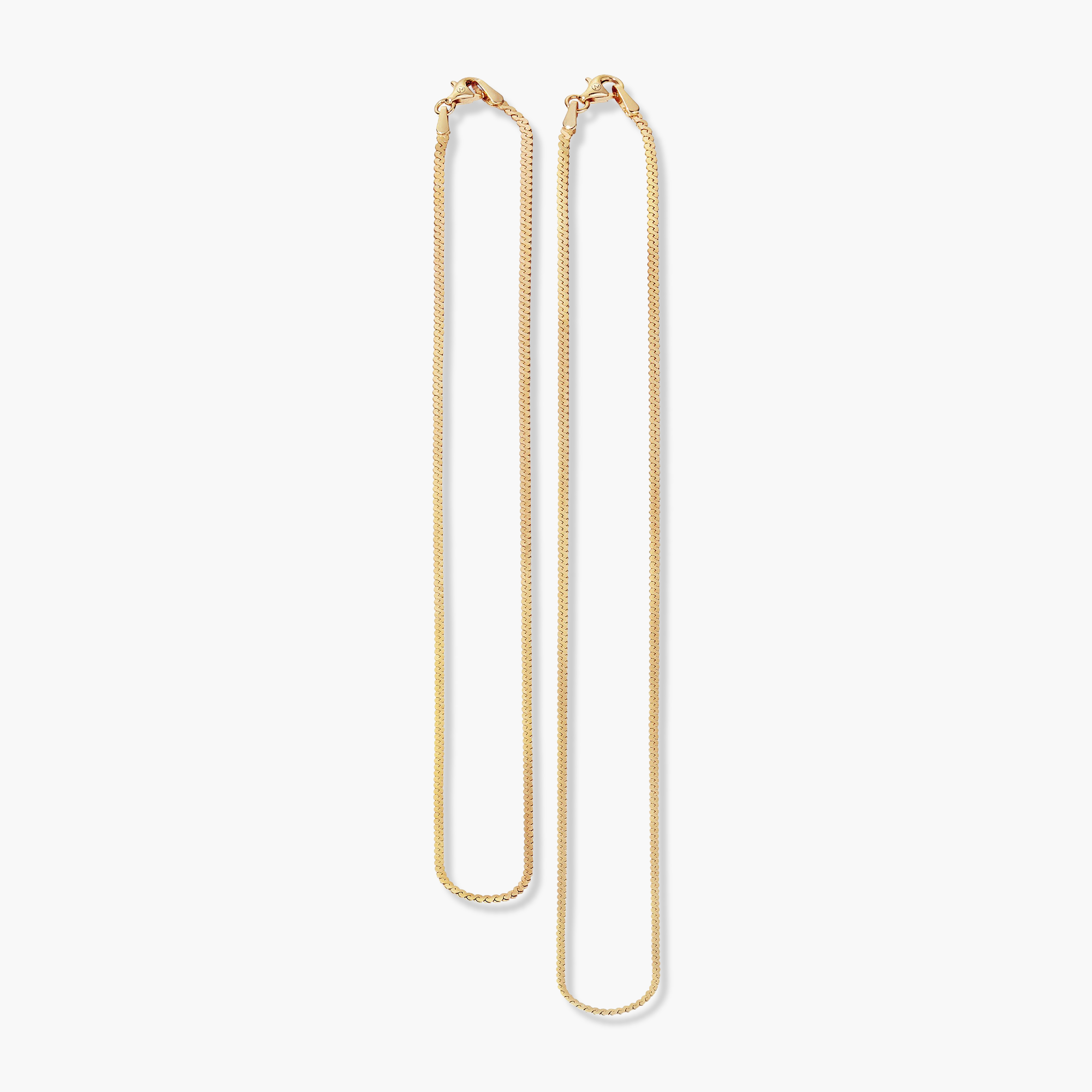 Serpentine Chain Necklace: A close-up of two minimalist gold chains, elegantly designed for versatile wear, making a bold statement with subtlety.