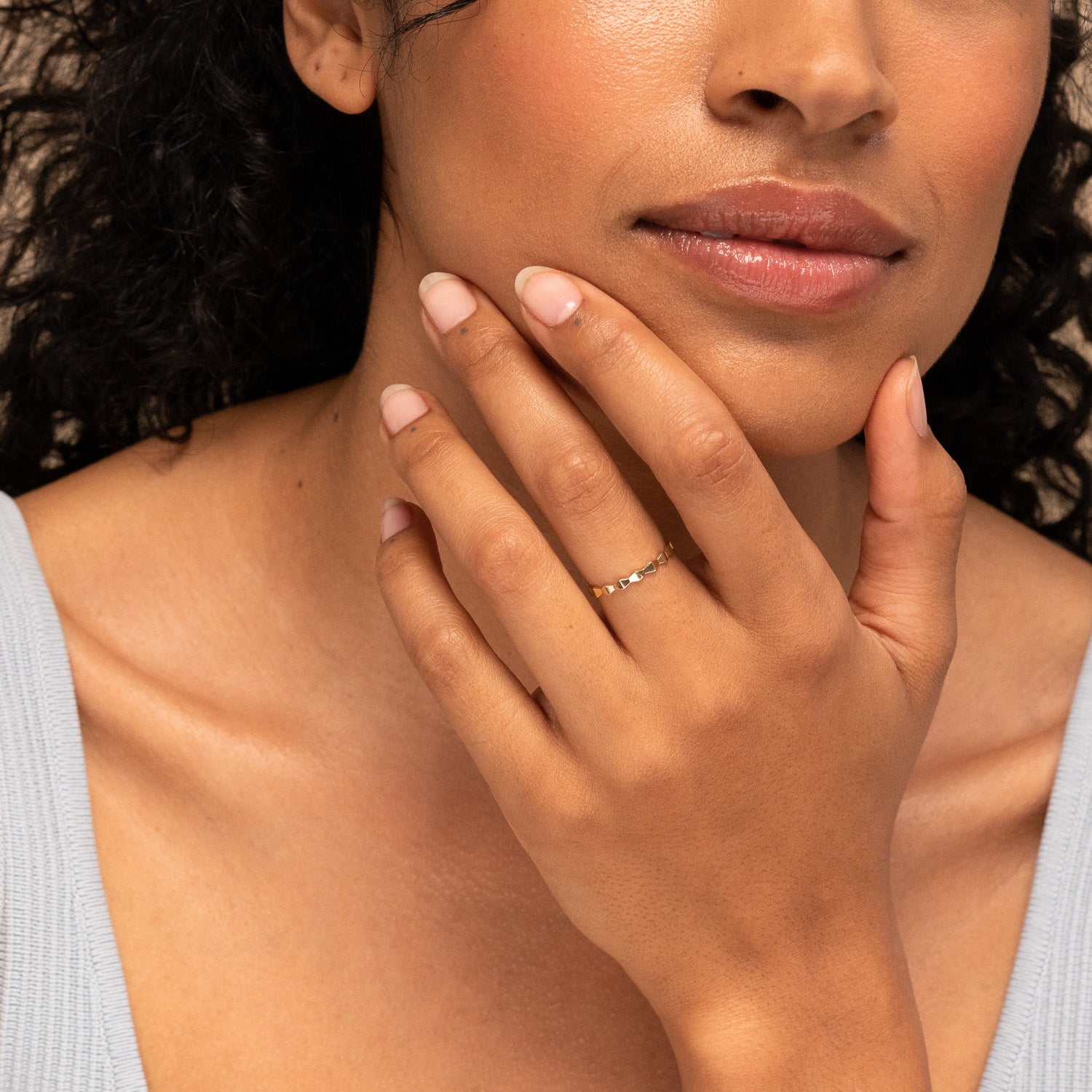 Close-up of a woman wearing the Sculpture Ring, showcasing its intricate design as a bold fashion accessory on her hand.