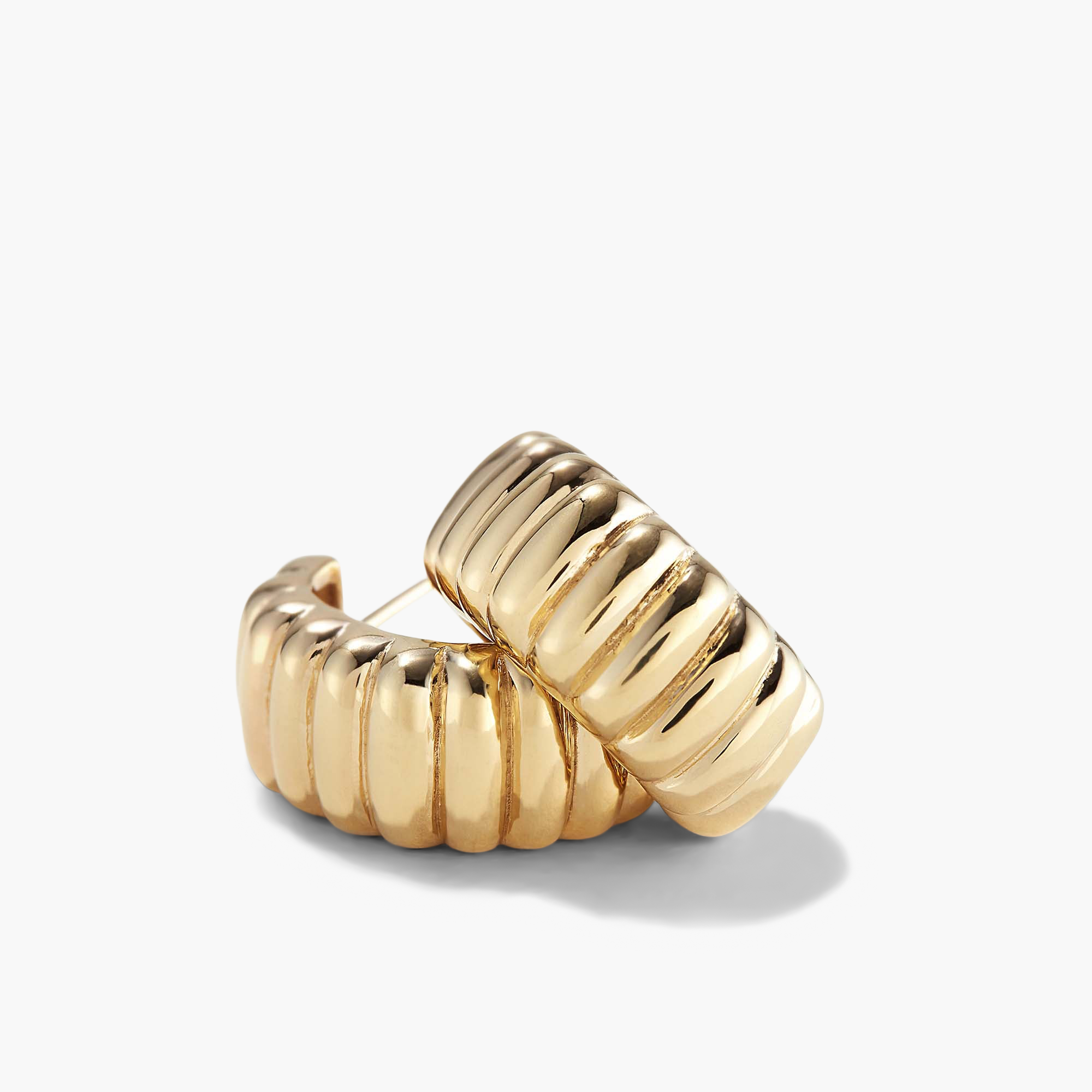 Charlotte Bold Hoops: Close-up of a pair of intricately designed gold hoop earrings, inspired by the iconic French dessert.