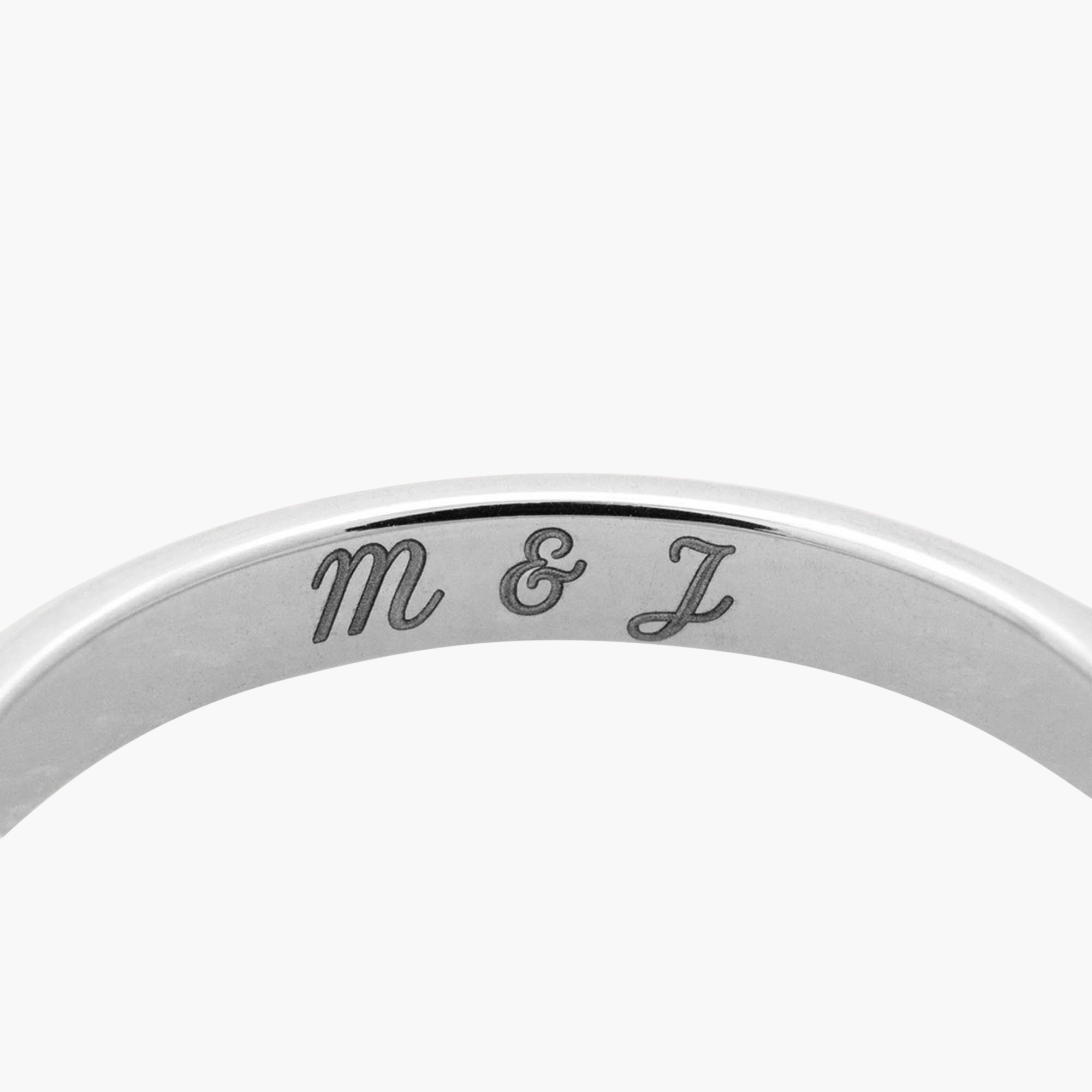 Diamonds Cluster Ring with engraved letters and eleven diamonds in prong settings, featuring an asymmetric, organic design.