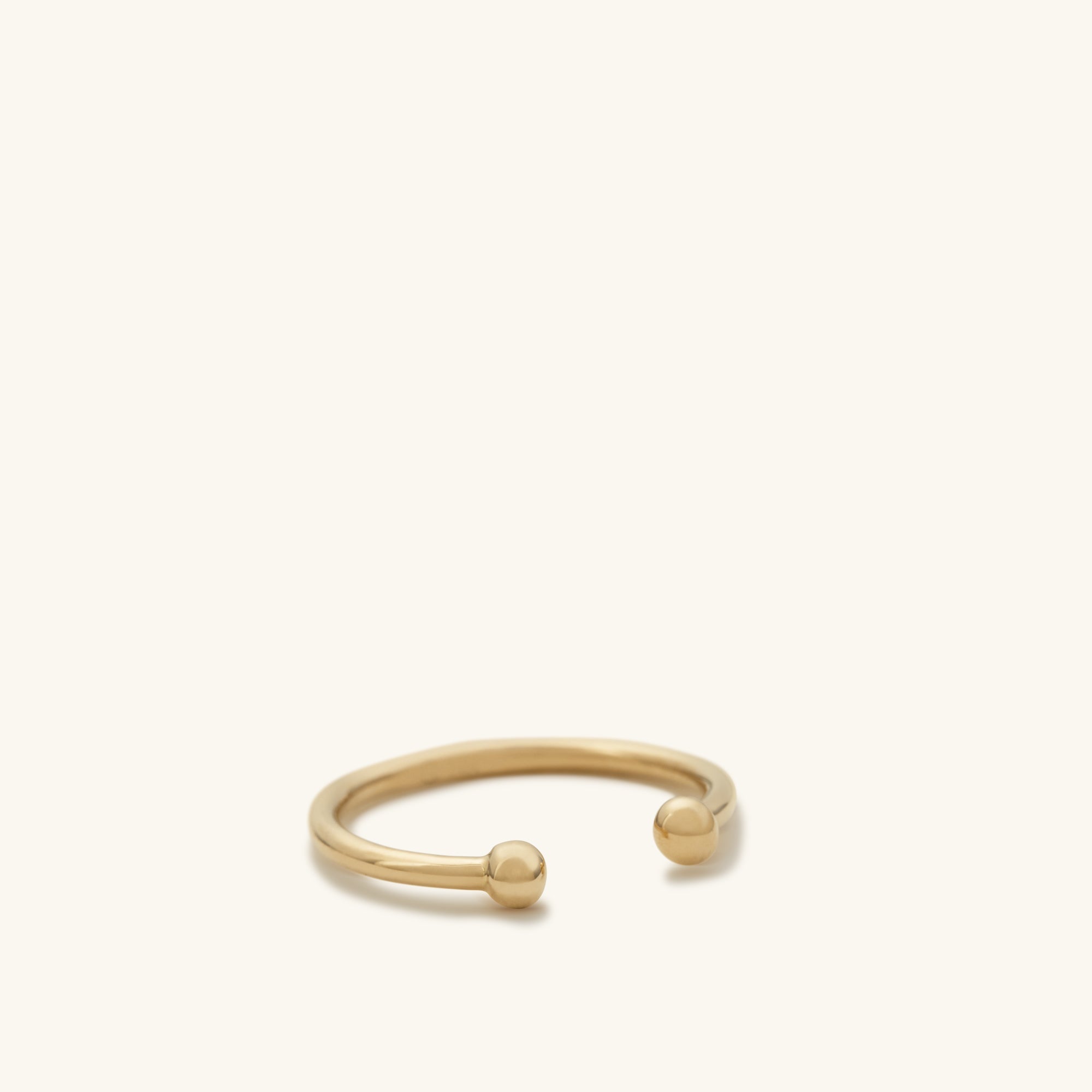 Essential Cuff: A close-up of a 14k solid gold ear cuff featuring a prominent ball detail, designed to enhance your jewelry stack.