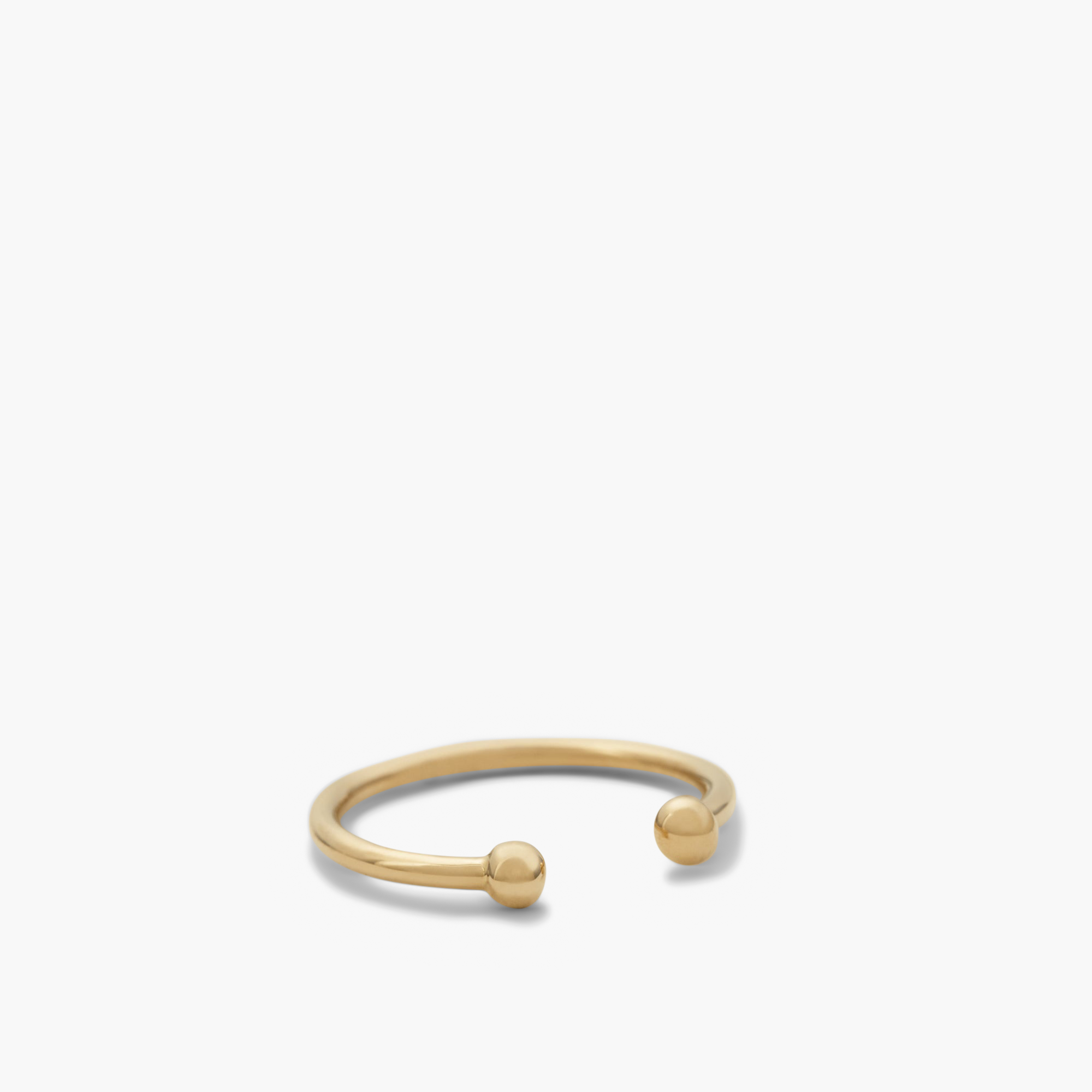Essential Cuff: A close-up of a 14k solid gold ear cuff featuring a prominent ball detail, designed to enhance your jewelry stack.