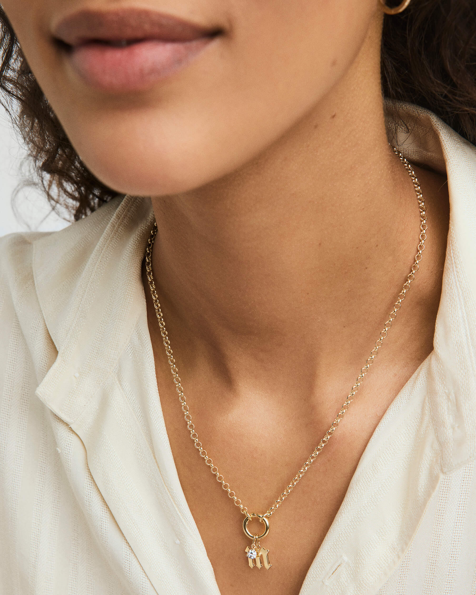 Close-up of a woman wearing a Gothic Letter Pendant necklace, showcasing its edgy, gothic-style design and intricate detailing.