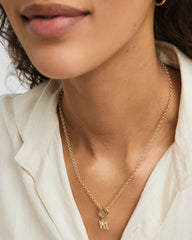 Close-up of a woman wearing a Gothic Letter Pendant necklace, showcasing its edgy, gothic-style design and intricate detailing.