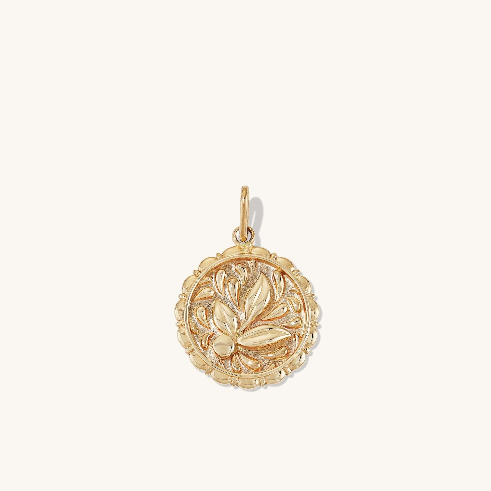 Balance: Terra Coin Charm Pendantâa gold medallion featuring an intricate leaf design, inspired by Greek Goddess Gaia, handcrafted in recycled 14k solid gold.
