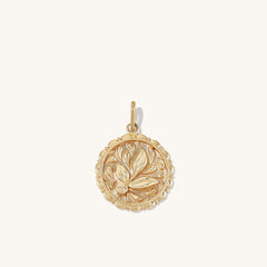 Balance: Terra Coin Charm Pendantâa gold medallion featuring an intricate leaf design, inspired by Greek Goddess Gaia, handcrafted in recycled 14k solid gold.