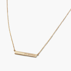 Engravable Bar Necklace with a slim horizontal bar pendant engraved with jacquelyn on a delicate gold chain, ideal for personalizing with meaningful text.