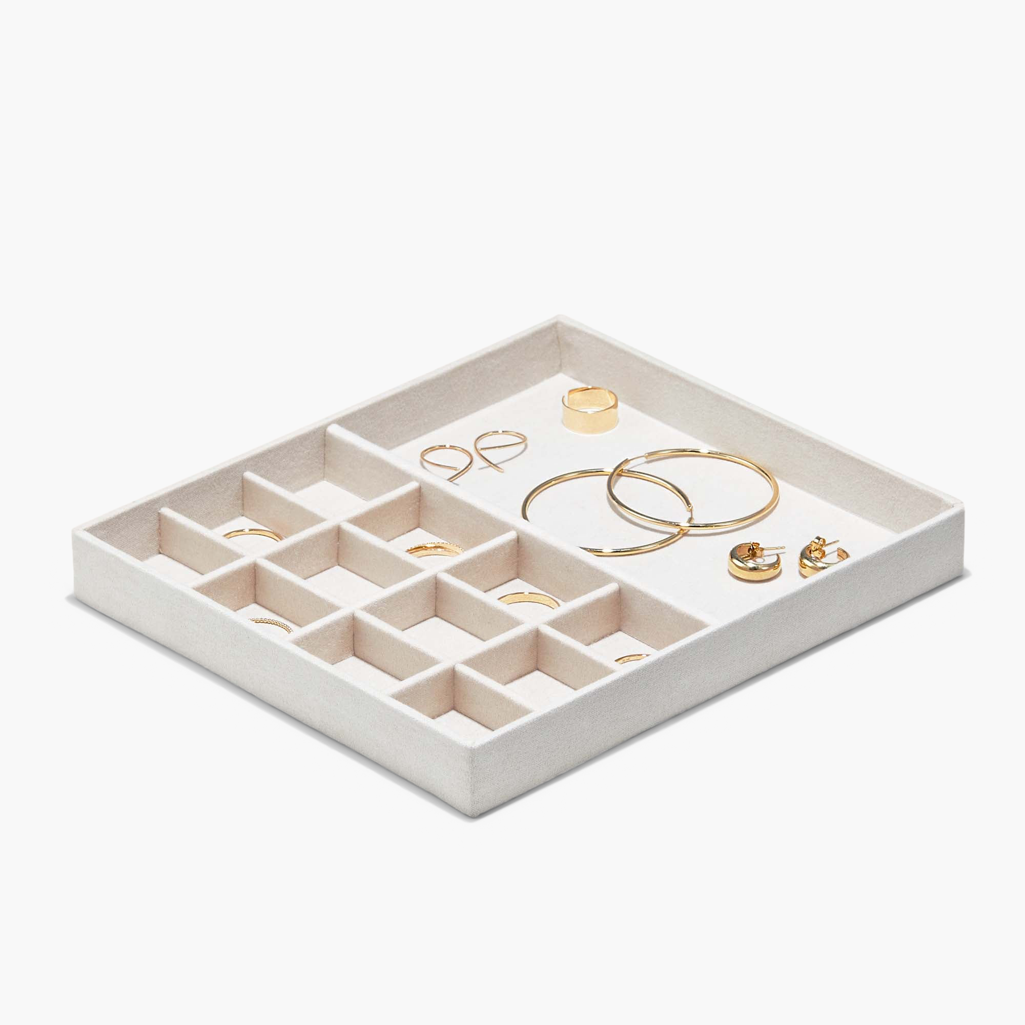Jewelry Box with cream tray, multiple compartments holding gold-tone rings and hoop earrings, offers organization with removable trays and monogram options.