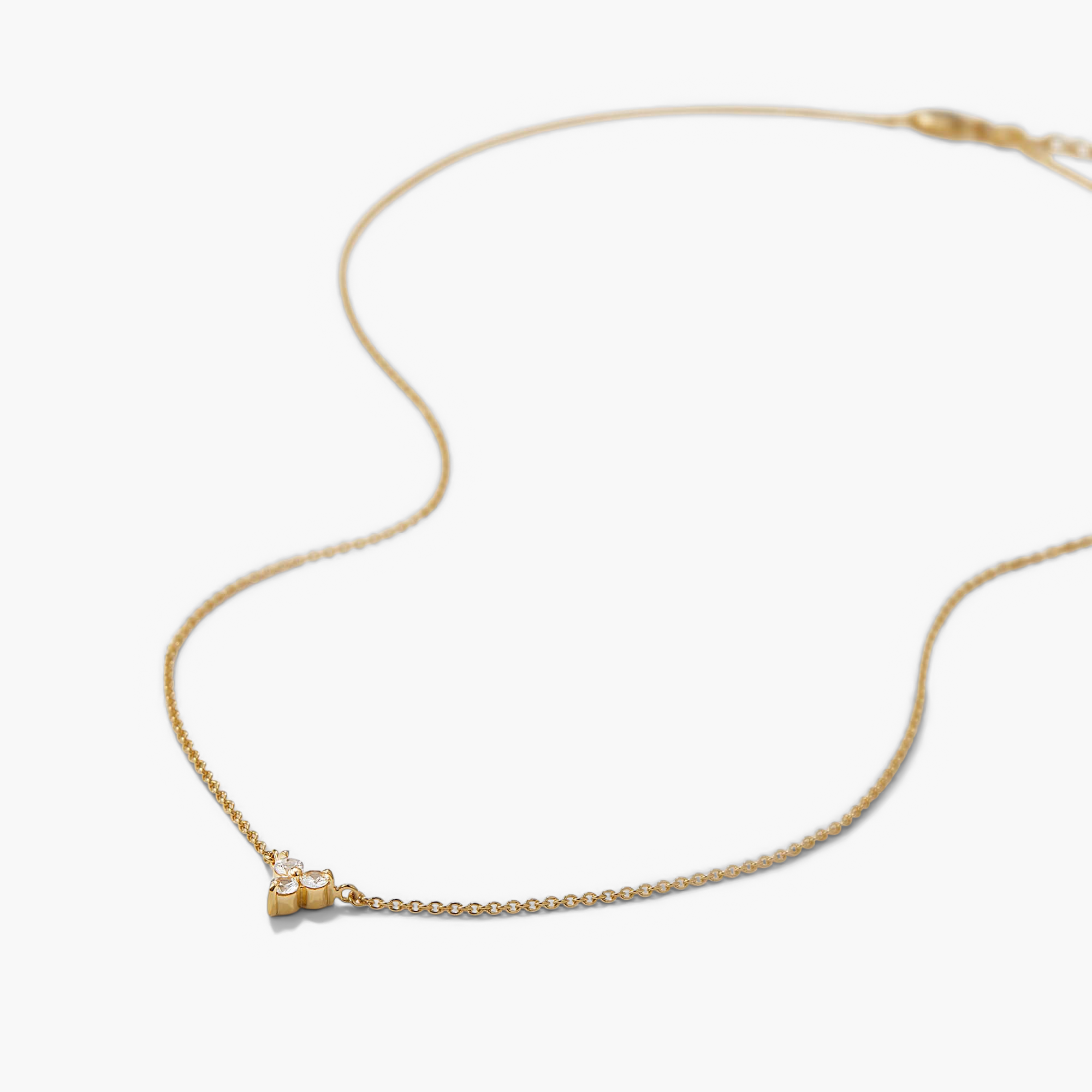 Lotus Necklace (Copy) featuring a delicate gold chain with a flower-like pendant of small clear gemstones, offering versatile elegance for any occasion.