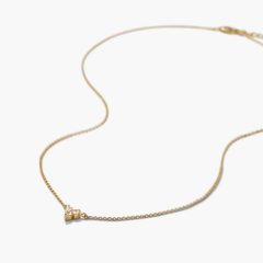 Lotus Necklace (Copy) featuring a delicate gold chain with a flower-like pendant of small clear gemstones, offering versatile elegance for any occasion.
