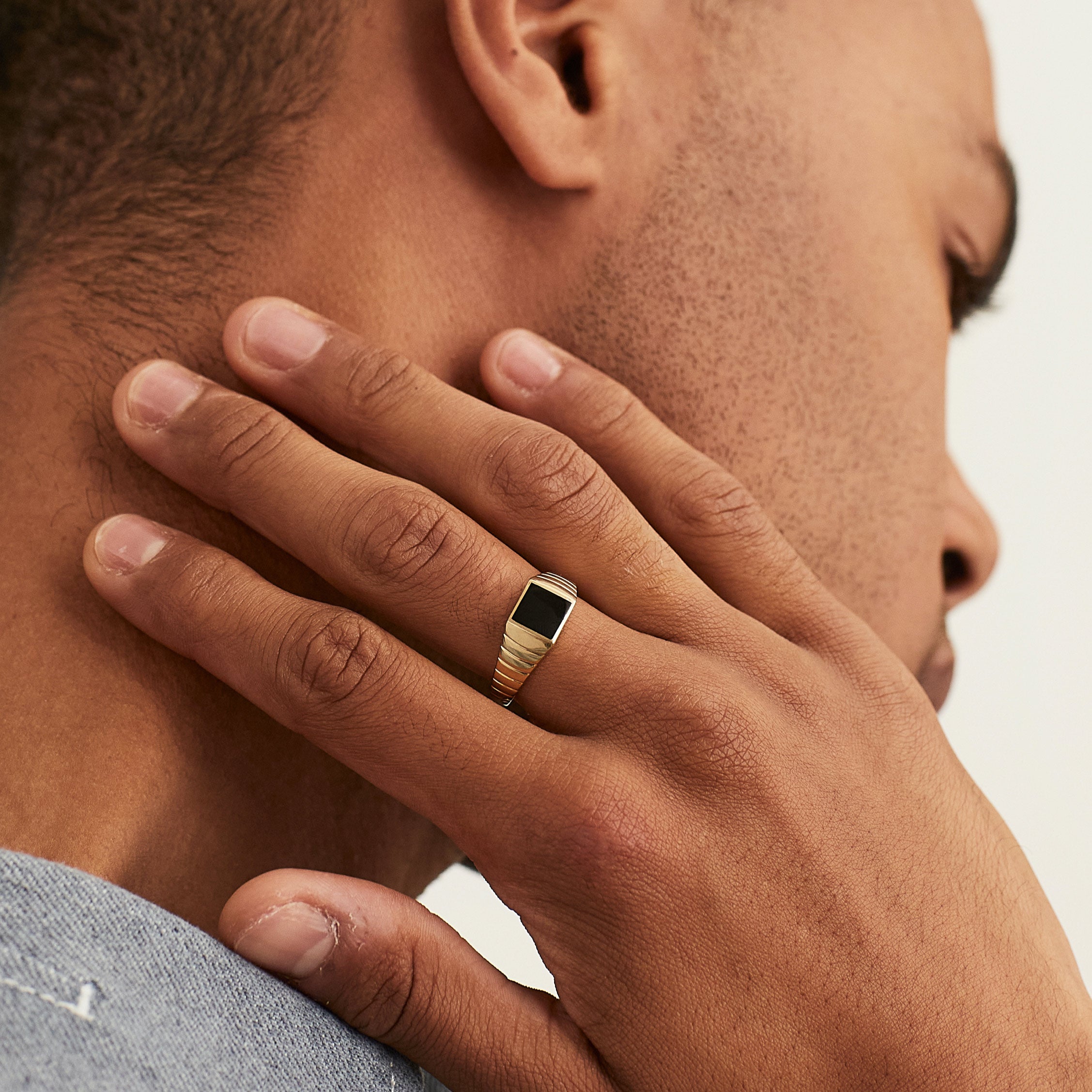 Black Onyx Square Signet Ring on a man's hand, highlighting the intricate design and elegance of the ring against the skin.