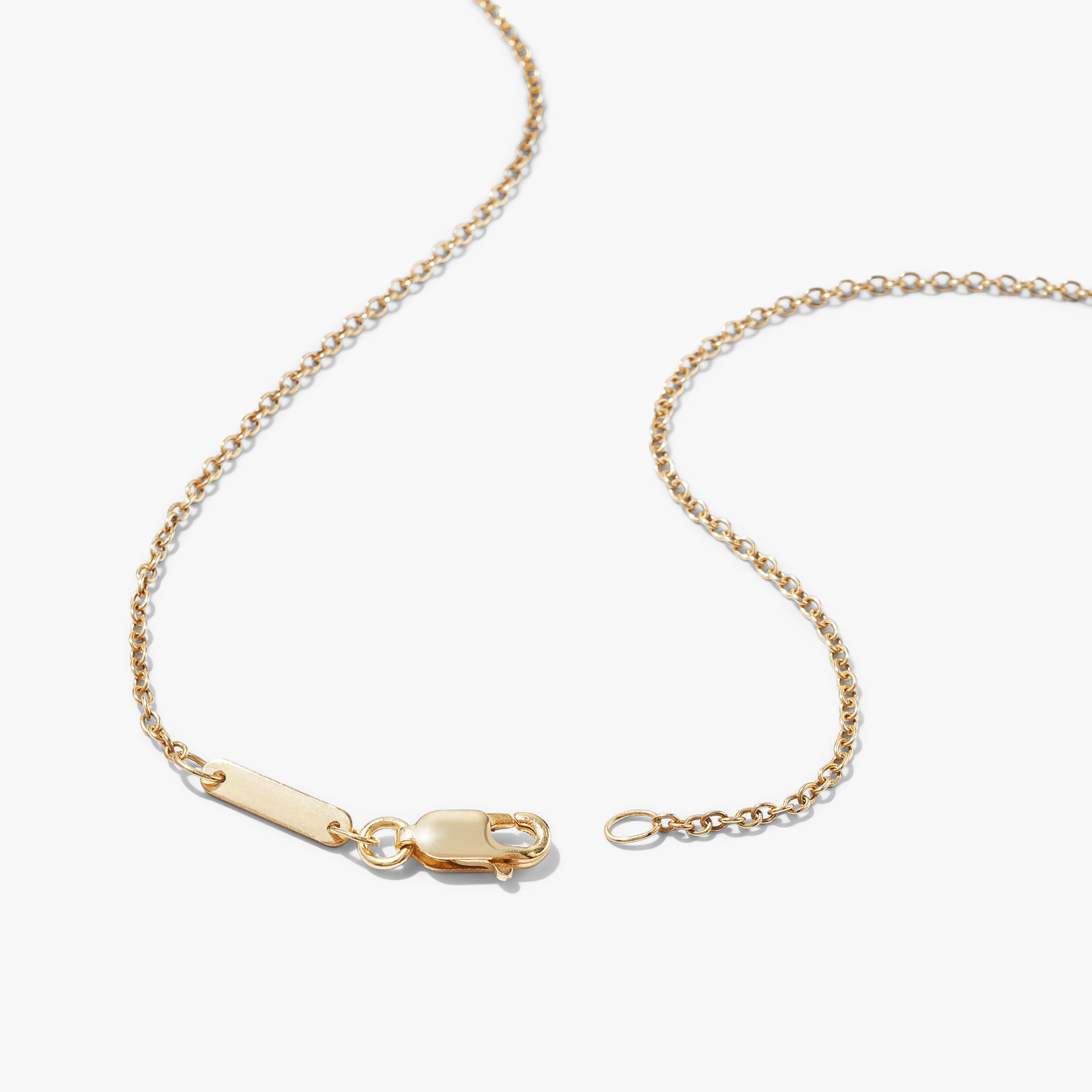 Black Onyx Pendant Necklace shown with a gold chain and a small tag, featuring a close-up of the pendant design.