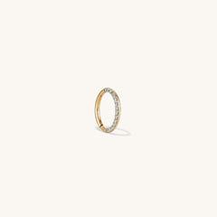 Cartilage PavÃ© Diamond Mini Hoop: A close-up of a 14k gold mini hoop earring with a pavÃ© diamond setting and hinge clasp for easy wear.