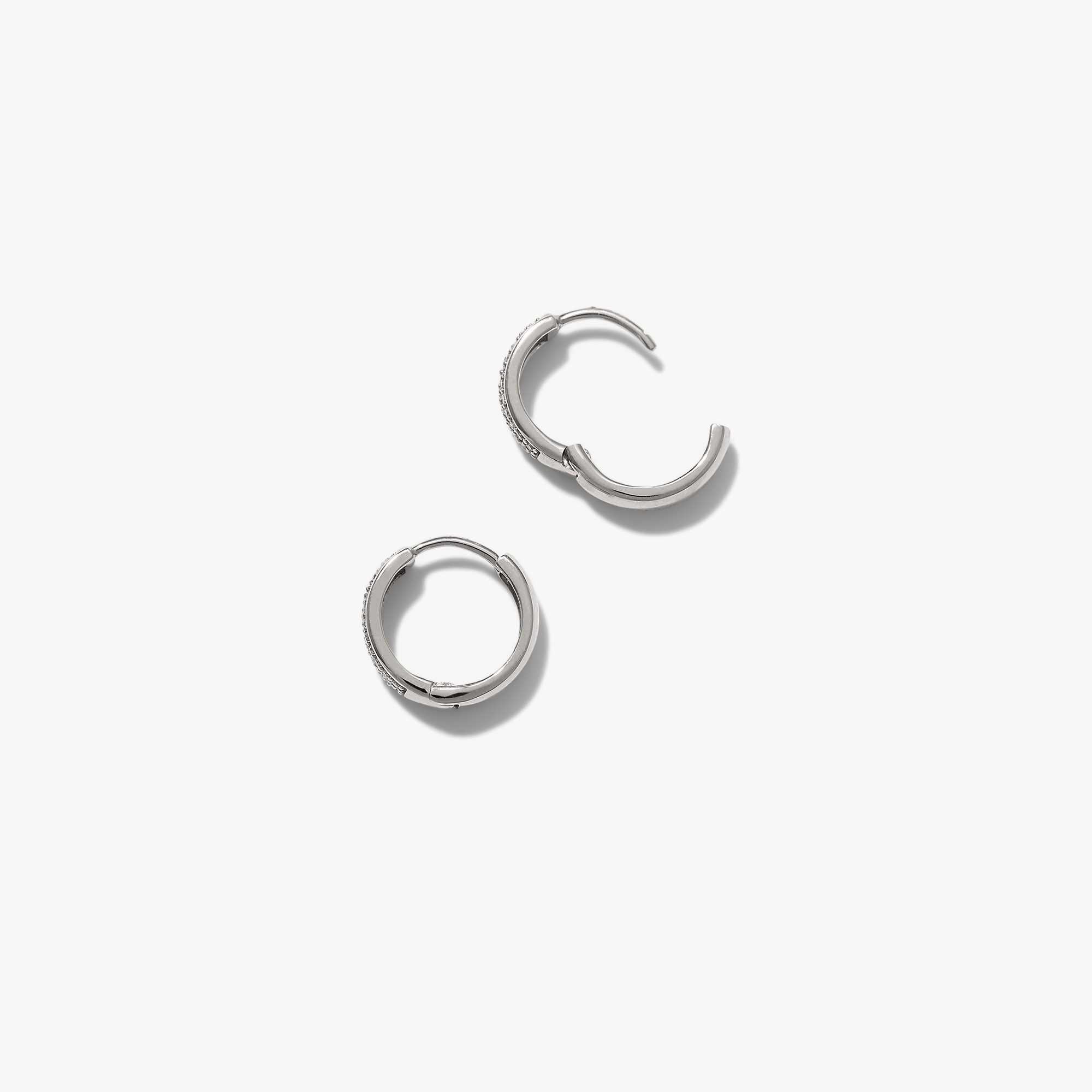 Bold PavÃ© Diamond Huggie Hoops, a pair of silver hoop earrings adorned with responsibly sourced diamonds, handcrafted in 14k solid gold for a sparkling, elegant look.