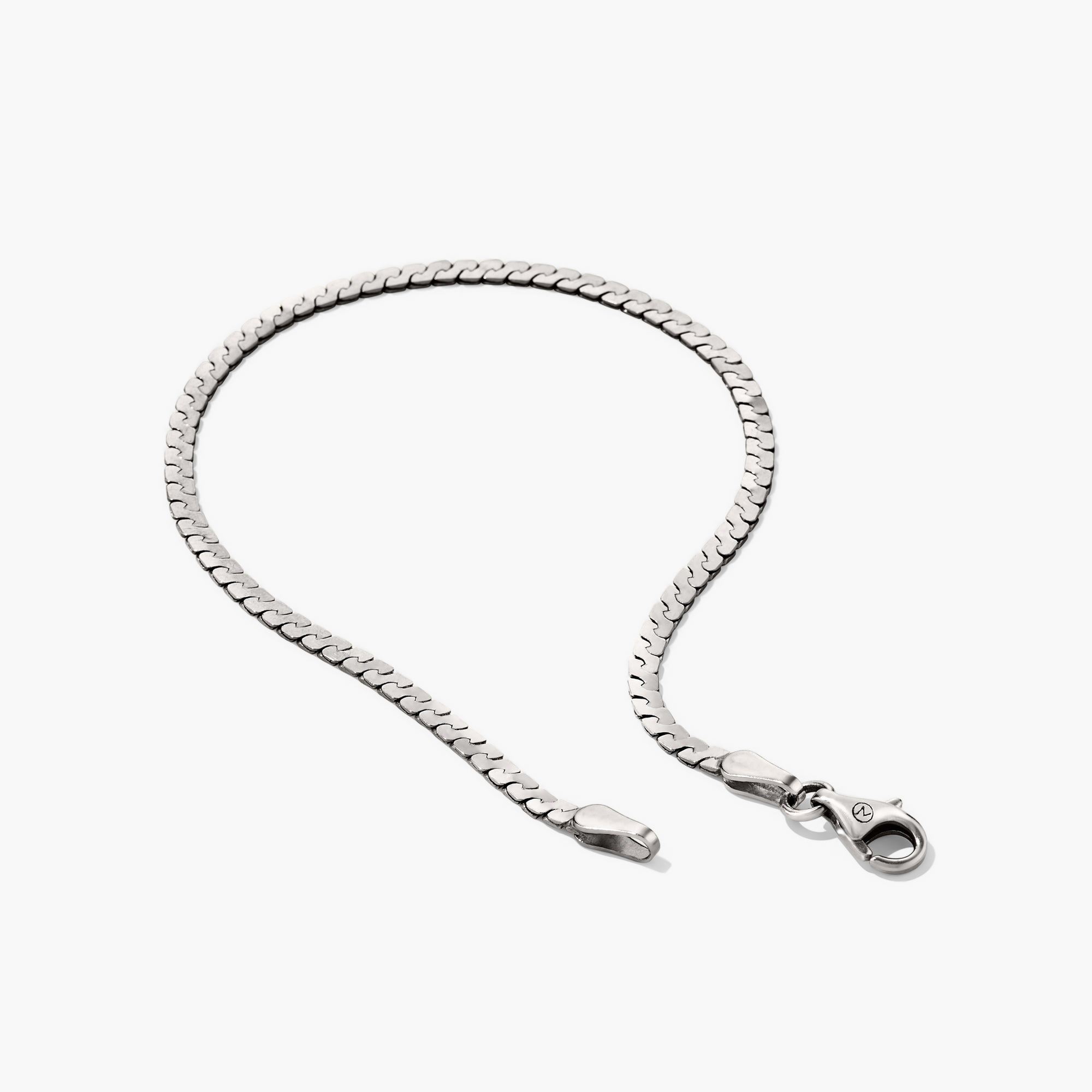 Serpentine Chain Bracelet with flat, braided silver links and a clasp, designed for all-day comfort on a white background.