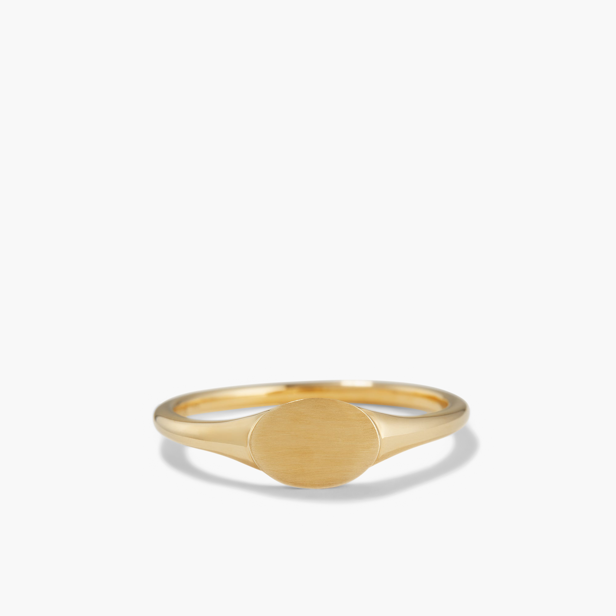 Signet Ring: A close-up of a 14k solid gold ring with a circular bezel, perfect for engraving an initial.
